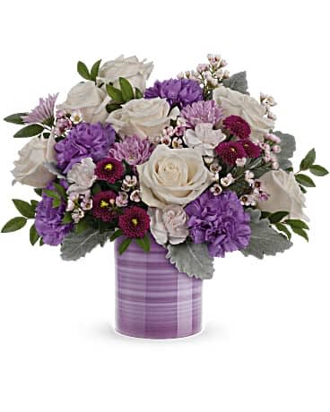 Serene Swirl Bouquet Serene Swirl Bouquet - Swirling with hand-painted bands of soft lavender, this sweet ceramic keepsake vase makes a marvelous Mother's Day gift filled with a bouquet of creamy roses and purple blooms. Please note that vase will be in purples, but style of vase may vary