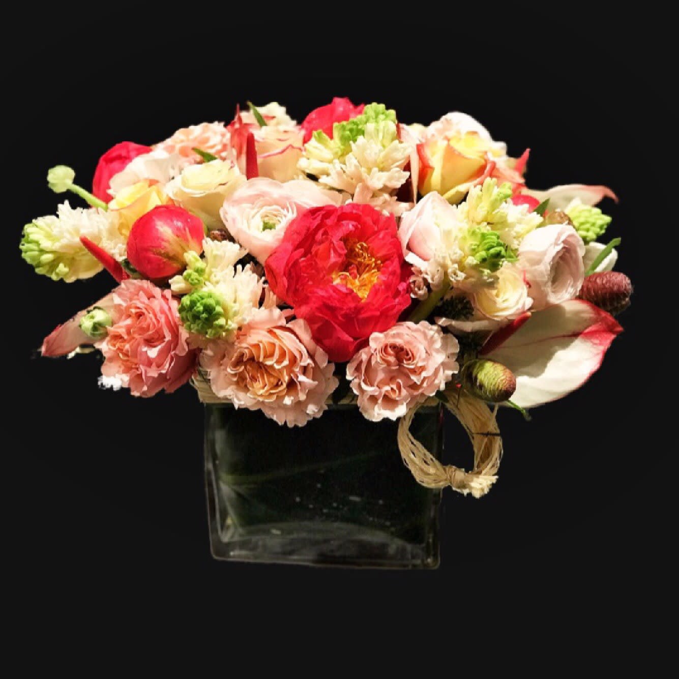 FLUFFY PEONIES ARRANGEMENT FLUFFY PEONIES ARRANGEMENT - A la rose, mesmerizing hues with coral peonies, ranunculos, white hyacinths.