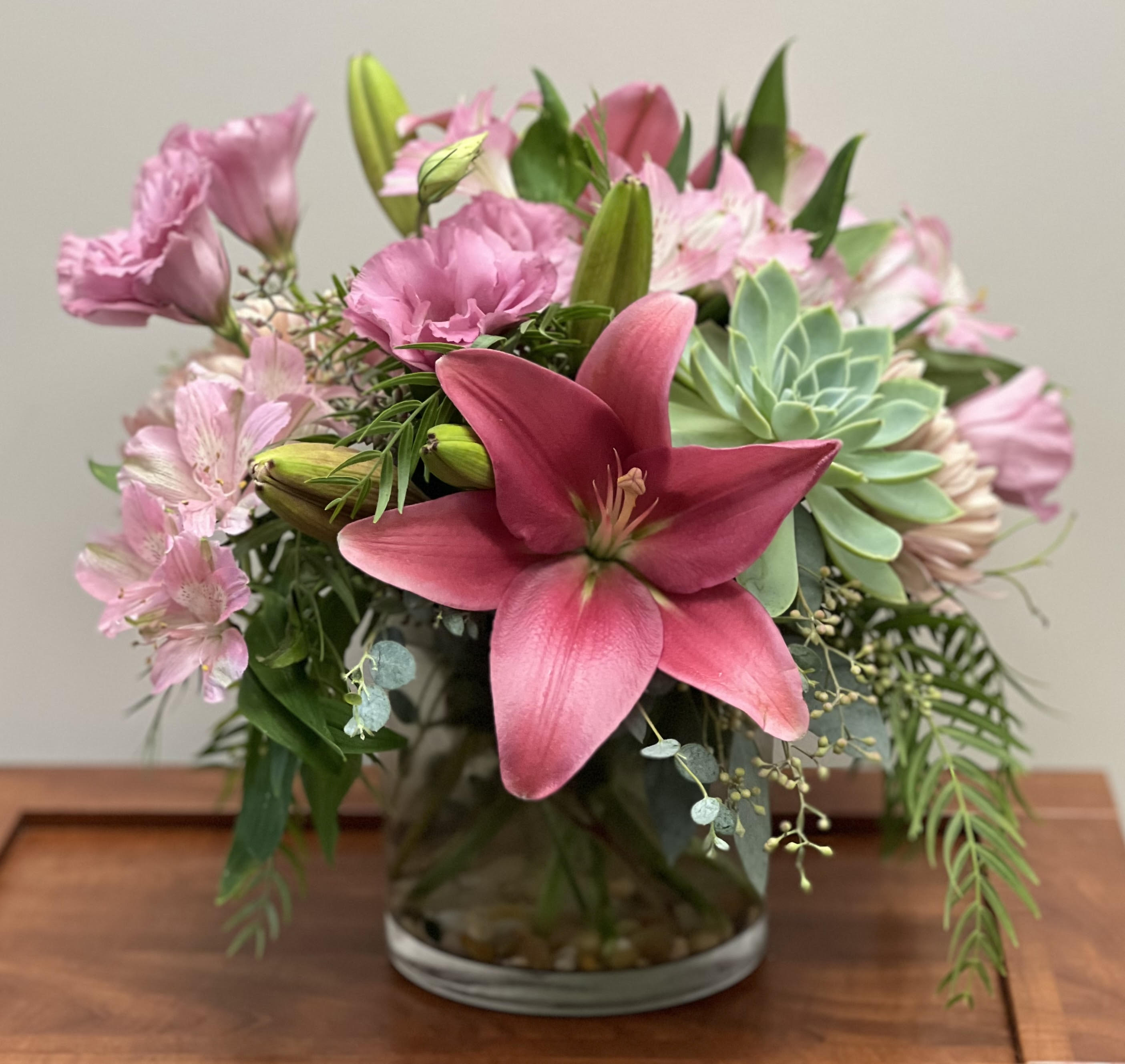 Pink Passion Pink Passion - A beautiful arrangement with pink lilies, pink alstroemerias, pink lisianthus and a succulent and greens. A beautiful pink statement!