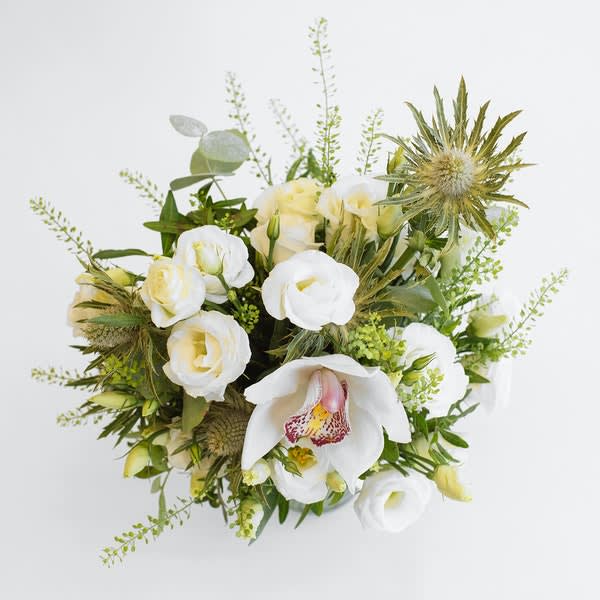 Angel Delight - A Delicious arrangement of heavenly white lisianthus thistle and glorious cymbidium orchid. 