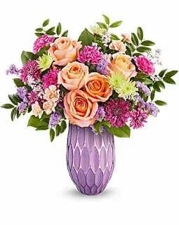 Pretty Glow Bouquet - Make her Mother's Day shine with Teleflora's Pretty Glow Bouquet, featuring a stunning mix of roses, carnations, and chrysanthemums, beautifully presented in a sculpted glass vase with a purple mercury-inspired finish. This vibrant arrangement is a perfect blend of elegance and charm to brighten her special day.