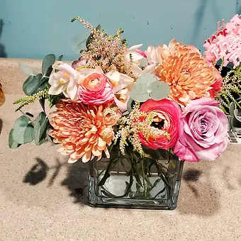 Summer Sunset - Brimming with peachy Ranunculus, some Cremon, a dash of Astilbe with a Pink Rose and Eucaluptus greenery finish.