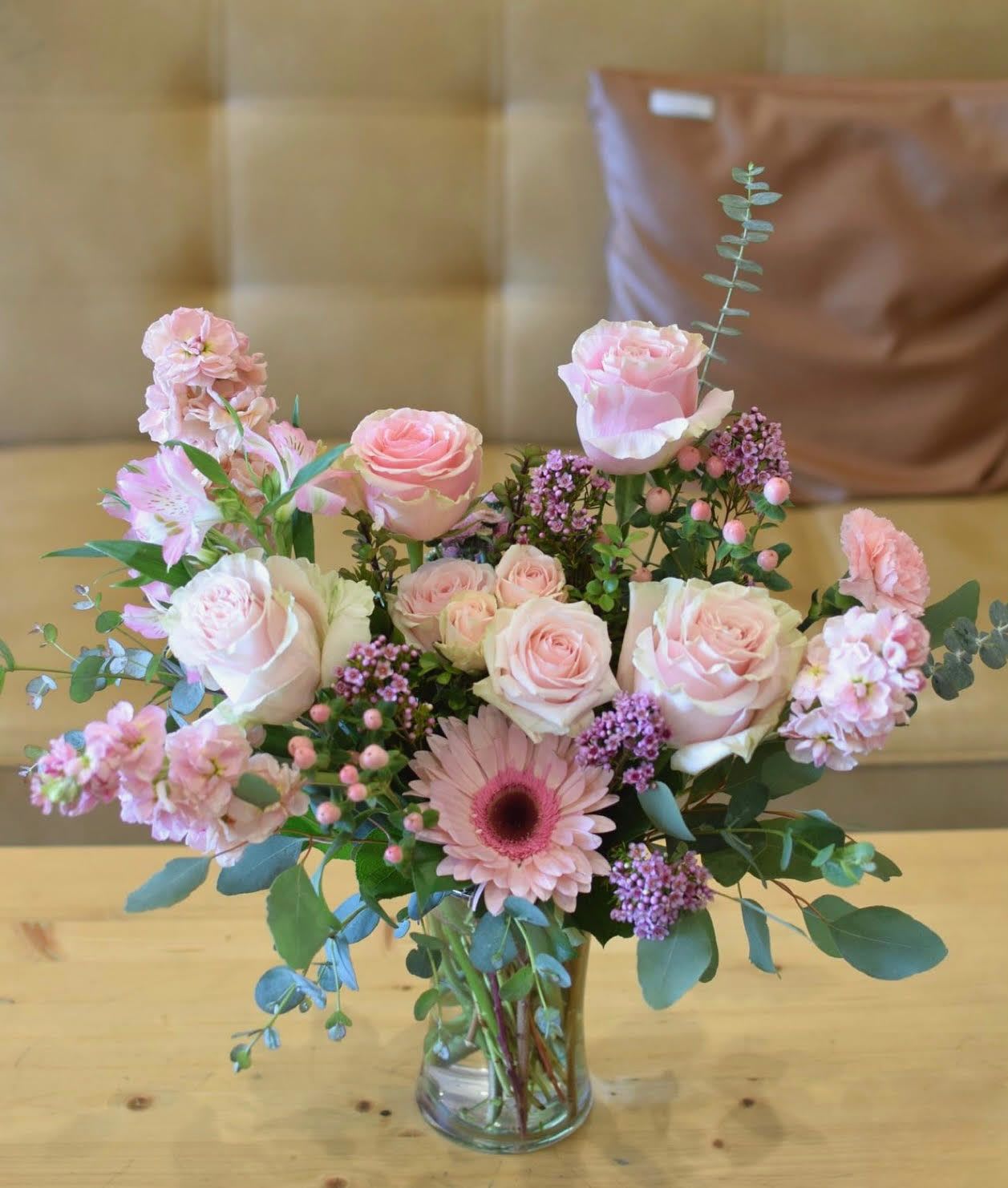 Blushing Blooms - Enjoy the soft romance of our 'Blushing Blooms' arrangement, featuring a delicate mix of pink roses, carnations, and gerbera daisies. This stunning bouquet is carefully crafted to evoke feelings of love and appreciation, making it the perfect gift for any occasion. The subtle blush tones and lush greenery create a beautiful, delicate display that will brighten up any room. Show someone special how much you care with this gorgeous and elegant arrangement.