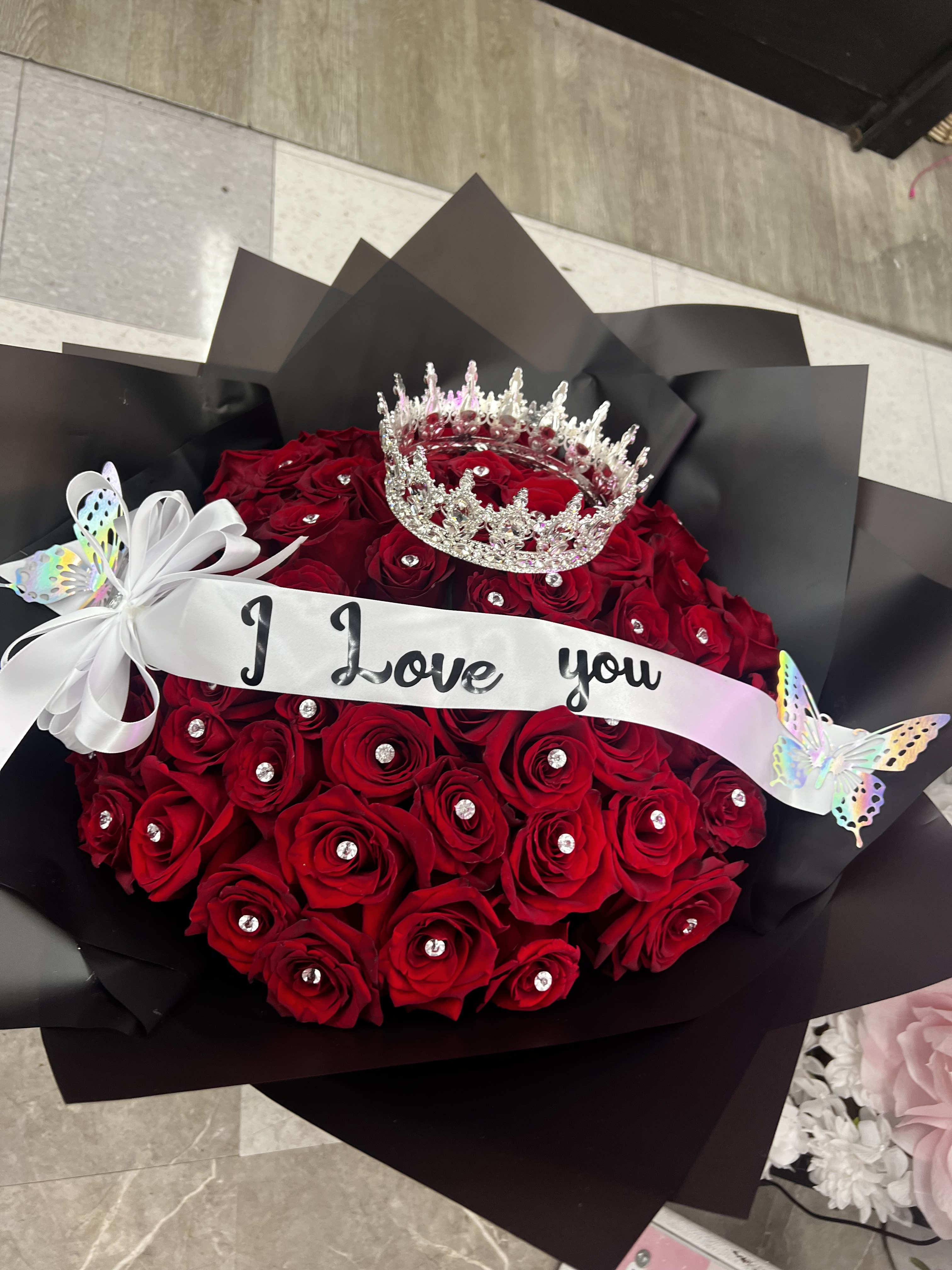 60 Roses with crown and diamond pins  - It comes with 60 red roses I love you Ribbon , 1 crown large (might be silver or gold ) we don’t have red all the time. . and it comes with  the diamond pins . 