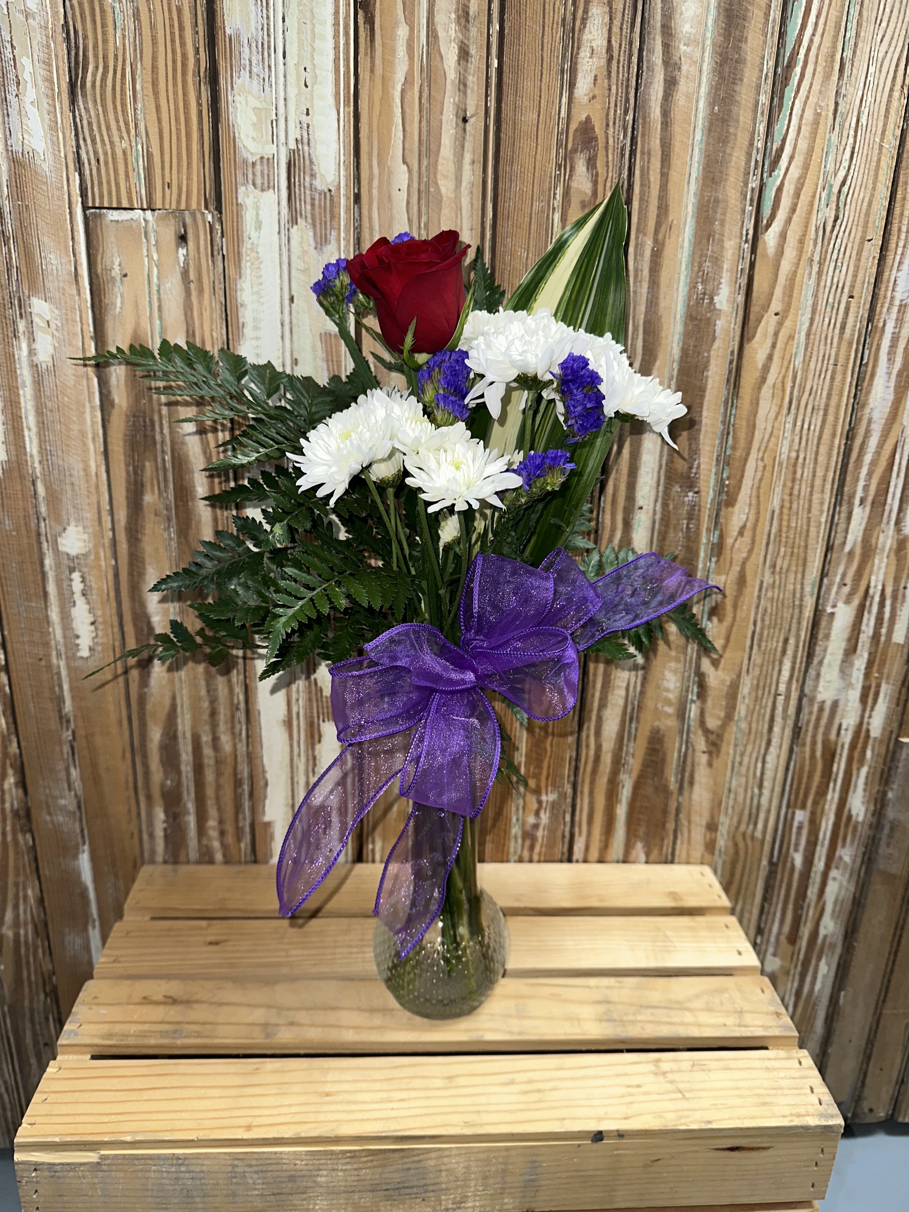 Single Rose Arrangement - This selection of a single rose in a vase is a timeless selection. Simple, yet elegant, it conveys a message of love and caring. If there is a preferred rose color, please let us know in the special instructions. 