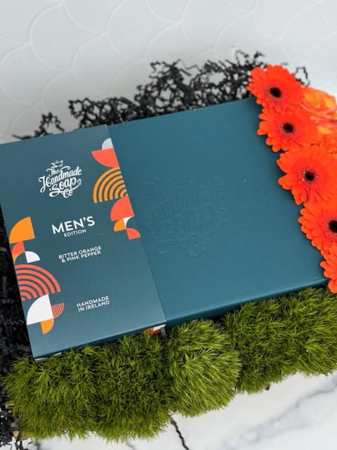 Gentlemen's Gift Box - A beautiful display in a wooden crate filled with orange and green florals, and our &quot;Men's Edition&quot; gift package from 'The Handmade Soap' company. This gift package features full size Shaving Gel, Hair &amp; Body Wash, and After Shave Balm. All products from the 'The Handmade Soap' company handmade in Ireland, all natural, Vegan friendly and Cruelty Free. It is the perfect gift for any man in your life!