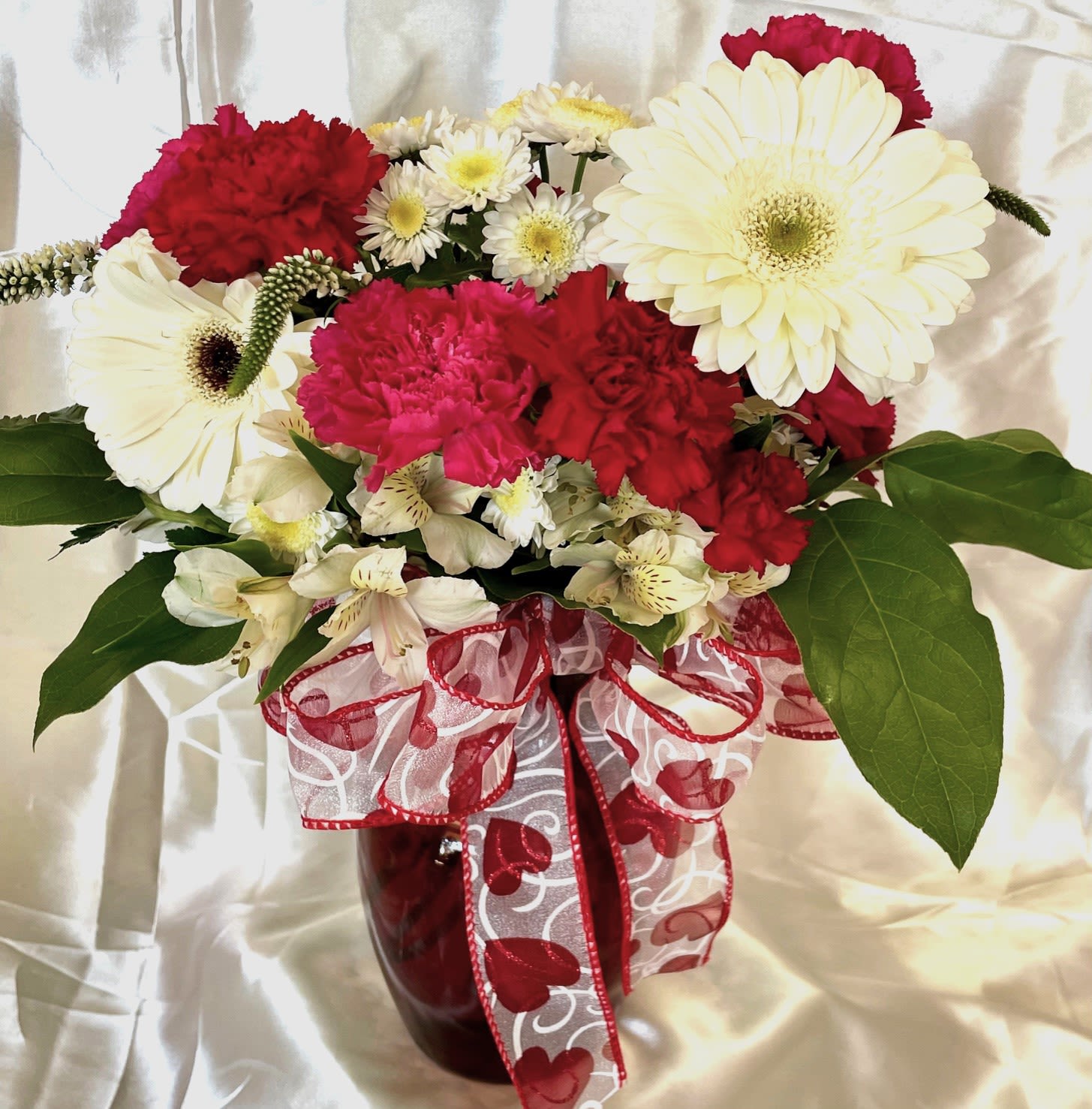 Full Heart Full Heart - Pretty and colorful arrangement of reds, pinks, and white in a beautiful red glass vase.