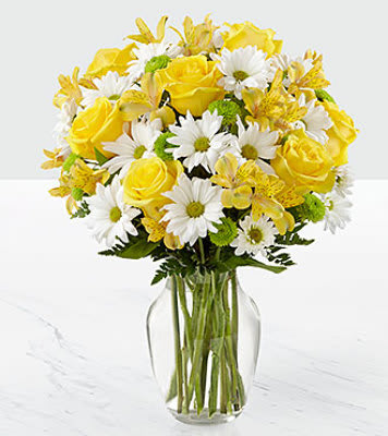 Sunny Sentiments Bouquet - The FTD Sunny Sentiments Bouquet has a warm, welcoming look that will win over your special recipient with each sunlit bloom. Yellow roses and Peruvian Lilies are set to brighten their day, arranged amongst bright white traditional daisies, green button poms, and lush greens to create a stunning presentation. Arriving arranged to perfection in a clear glass vase, this fresh flower bouquet is ready to help you send your sweetest thank you, thinking of you, or get well wishes.