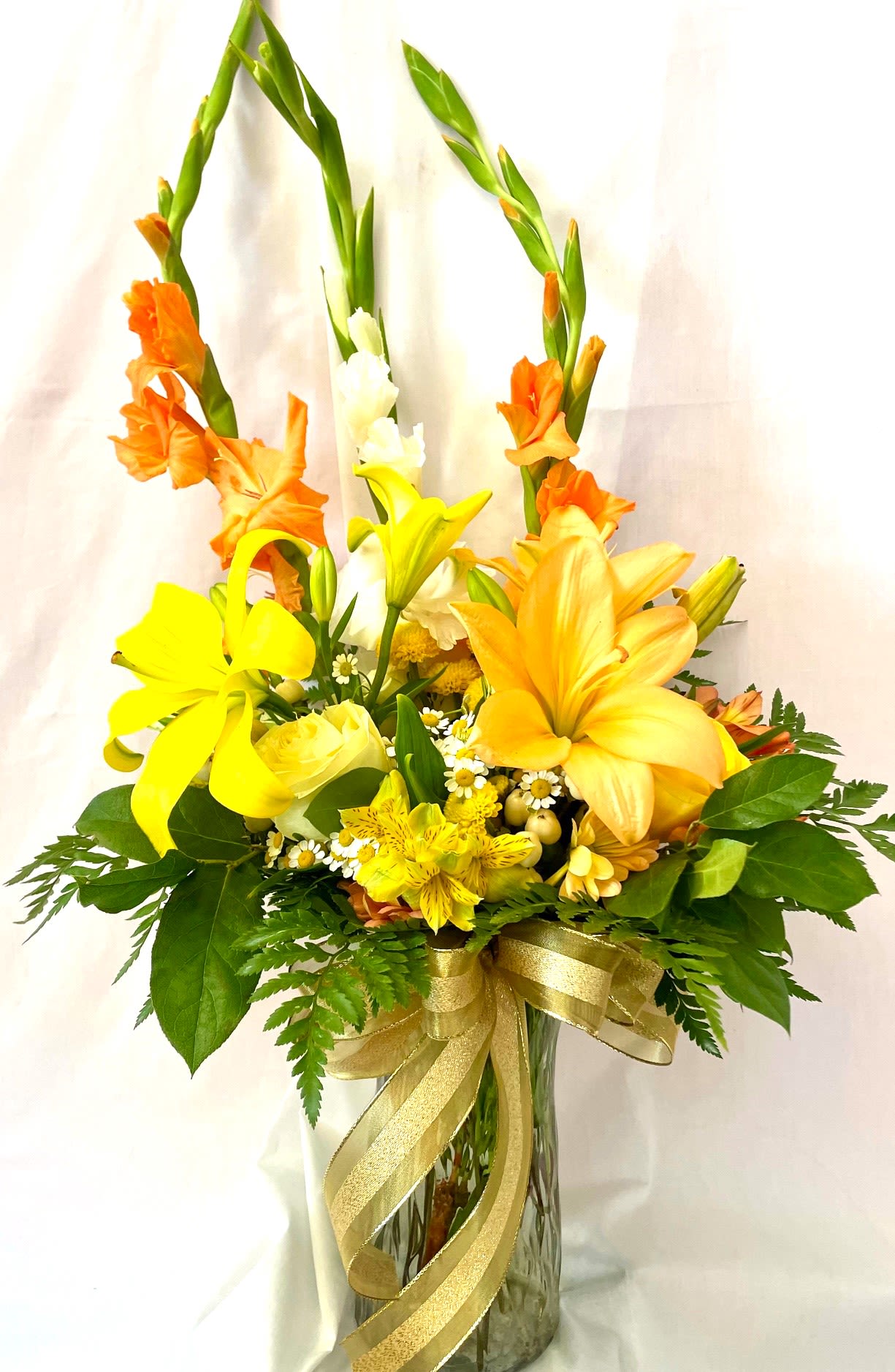 Sunny Disposition Arrangement Sunny Disposition Arrangement - Send some sunny vibes to someone special. This tall and colorful arrangement is sure to bring that touch of sunshine with beautiful color.