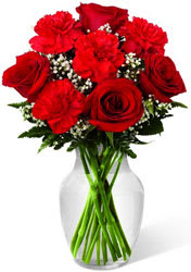 Sweet Perfection Bouquet - The Sweet Perfection Bouquet is an eye-catching way to capture their attention. Rich red roses and carnations are beautifully set amongst baby's breath and lush greens in a classic clear glass vase to create a sweet sentiment of love and affection.