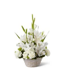 Warm Reflection Arrangement - The Warm Reflection arrangement is a peaceful offering of heartfelt sympathy. White gladiolus, Peruvian lilies, carnations, mini carnations and lush greens are beautifully arranged in a round whitewashed basket to create a beautiful display of soft serenity.