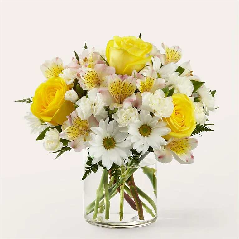 ️ &quot;Golden Glow Bouquet&quot; - A Fresh Burst of Sunshine and Smiles!  The Golden Glow Bouquet radiates warmth and happiness with a lively mix of bright yellow roses, white daisies, soft pink alstroemeria, and delicate white carnations — all beautifully arranged in a clear glass vase. It's a fresh and uplifting way to celebrate any special moment!   Fresh, hand-selected seasonal blooms  Perfect for birthdays, thank-yous, or “just because” gifts  Ready-to-display — vase included   Light up someone’s day with golden blooms and heartfelt joy!