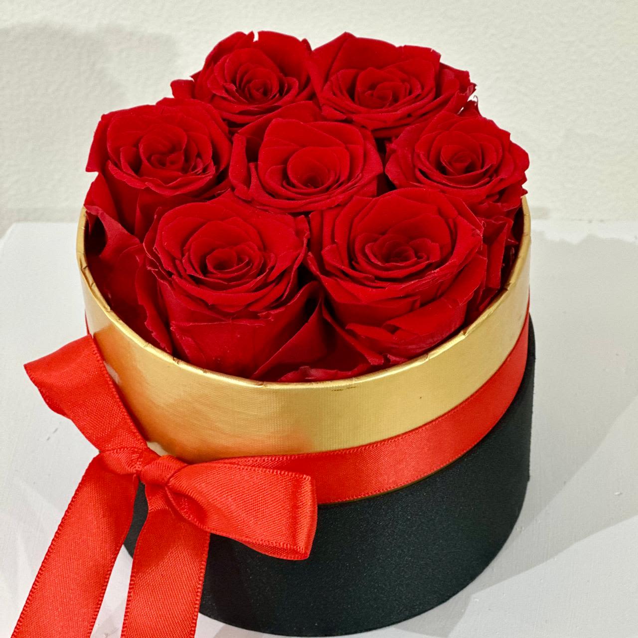 Long Lasting Pink Roses in a Round Box Mini - A charming and elegant arrangement featuring 7 stunning red roses in a sleek, small round box. Real roses that have been carefully treated to maintain their fresh look for months or even years. These everlasting blooms are perfect for expressing timeless love, passion, and elegance. No watering or maintenance required — just lasting beauty.