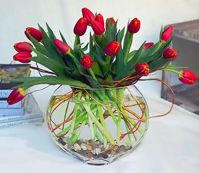 Forever Spring - A spectacular arrangement of two bunches of tulips arranged in a moon vase with curly willow!  All prices in USD ($)