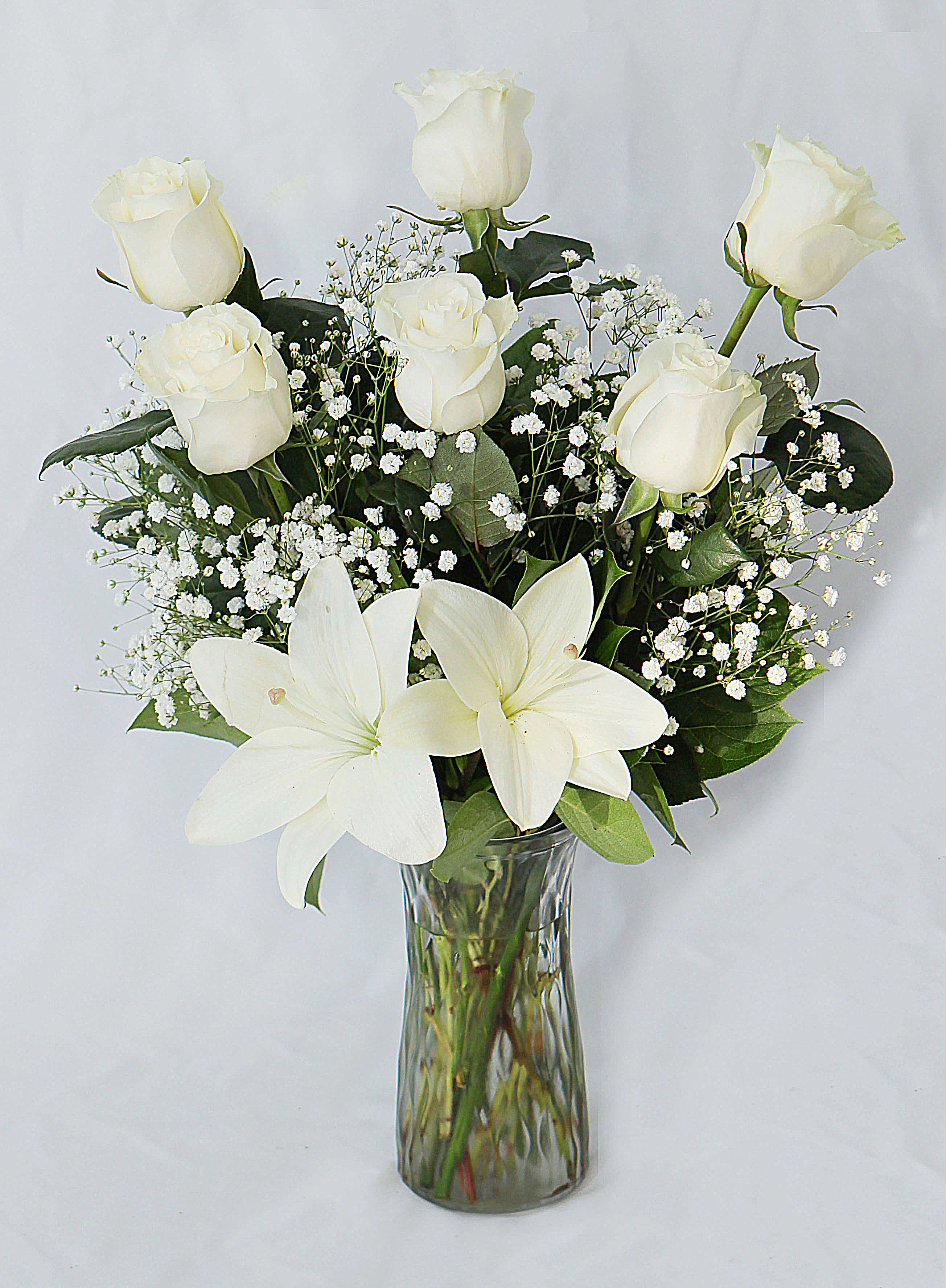 White Roses - This all white arrangement includes. roses, lily and greenery.