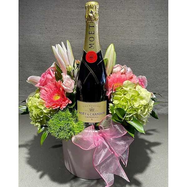 Sparkling Spring  - When you want to make a sparkling impression - send a bottle of champagne with a beautiful spring arrangement. The arrangment serves not only as a backdrop, but a holder. Perfect for home, restaurant or hotel room. YOU MUST BE 21 OR OLDER TO ORDER THIS PRODUCT. A SIGNTURE OF SOMEONE 21 OR OLDER WILL BE REQUIRED UPON DELIVERY.   All prices in USD ($)