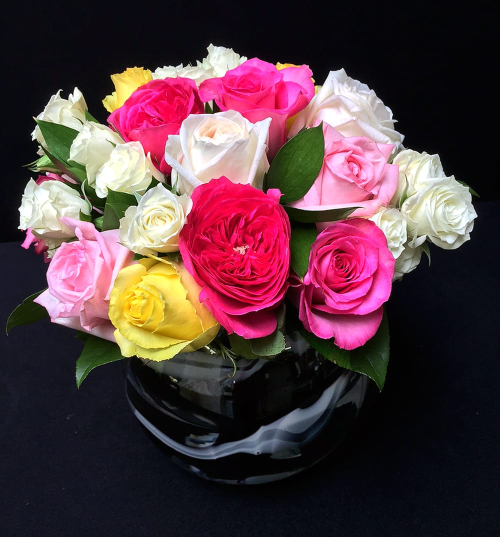 Rose Garden MD15-5 - An incredible mix of our best rose blooms presented in a glass leaf-lined vase. This is is keeper and a designer favorite!