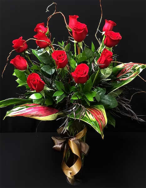 Deluxe Roses - Roses don't have to look like they did in the 1950's. Times have changed and so have our designers take on this traditional arrangement. Utilizing darker fillers and greens - this arrangement is perfect for a an office or even for a &quot;man cave&quot; or female friend that likes traditional with a twist. While Red Roses are a perfect complement for this arrangement - feel free to specify a different color choice in special instructions. Orders for roses in colors other than Red, White &amp; Yellow should be placed 48 hours in advance to ensure availability. NOTE: We only use imported long-stemmed roses that are 70+ cm long. These are considered the best of the best!  All prices in USD ($)  Standard: 12 Stems Deluxe: 24 Stems Premium: 36 Stems