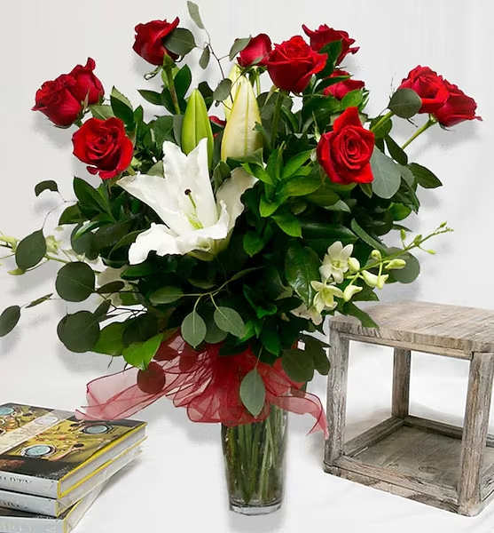 Signature Rose Arrangement - A stunning mix of 12, 24 or 36 premium long-stem roses, casablanca lilies and dendrobium orchids beautifully arranged in a clear glass vase. Choose from red, pink, yellow, white.  All prices in USD ($)  Standard: 12 Stems Deluxe: 24 Stems Premium: 36 Stems