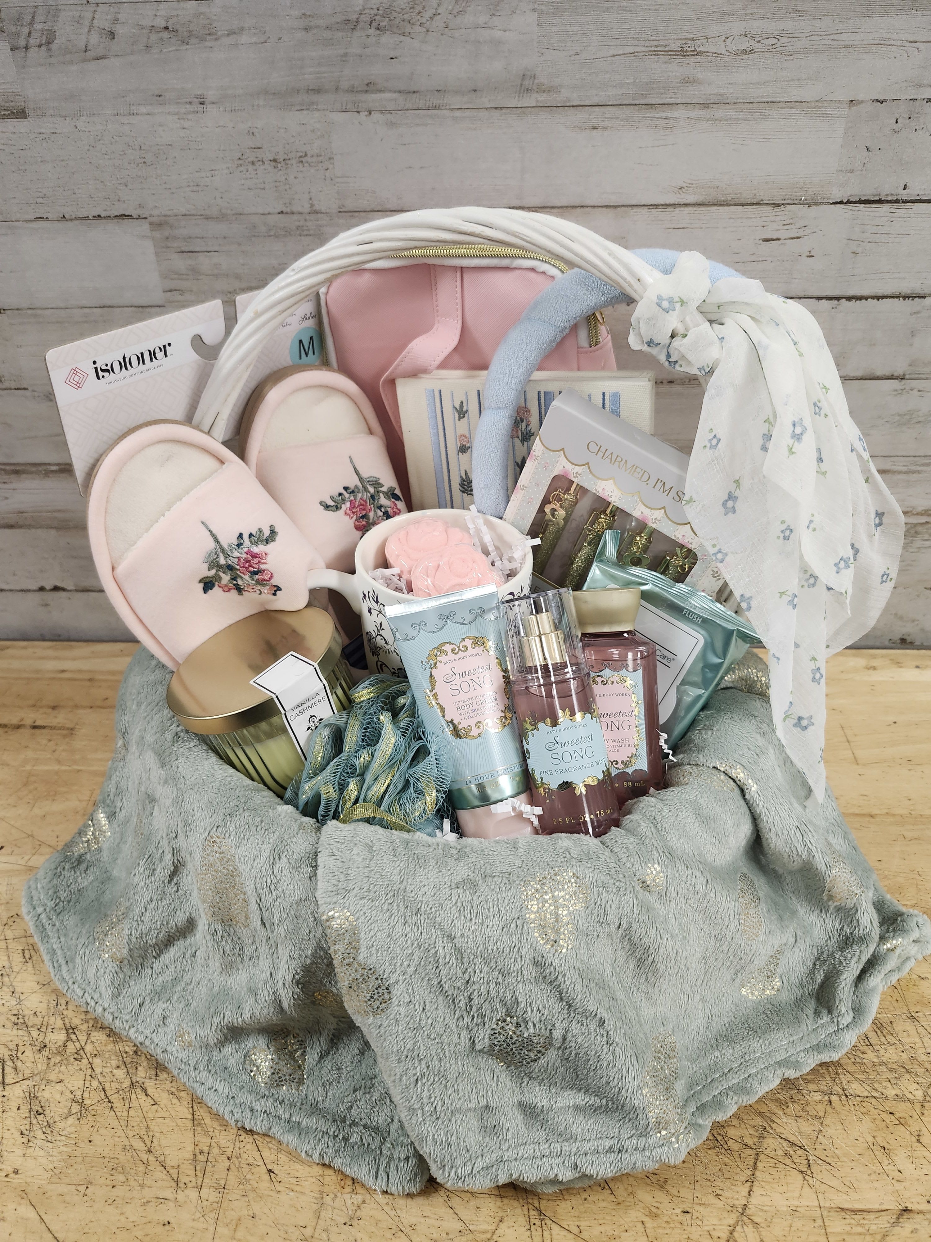 Classy Care Package - $150 - Baskets are one of a kind. Please call to order 504-341-4305.  This Classy Care Package is sure to please anyone who likes a little bit vintage and a whole lot elegant.   Basket Features:  - Plush Blanket - Embroidered Notebook - Pens with Charms - Cozy Embroidered Slippers - Coffee Mug - Candle - Mini BBW &quot;Sweetest Song&quot; Body Cream - Mini BBW &quot;Sweetest Song&quot; Shower Gel - Mini BBW &quot;Sweetest Song&quot; Fragrance Mist - Loofa - Headband - Makeup Wipes - Rose Shower Fizz x2 - Makeup Bag Ribbon Hair Tie  Delivered in a Wicker Picnic Style Basket 