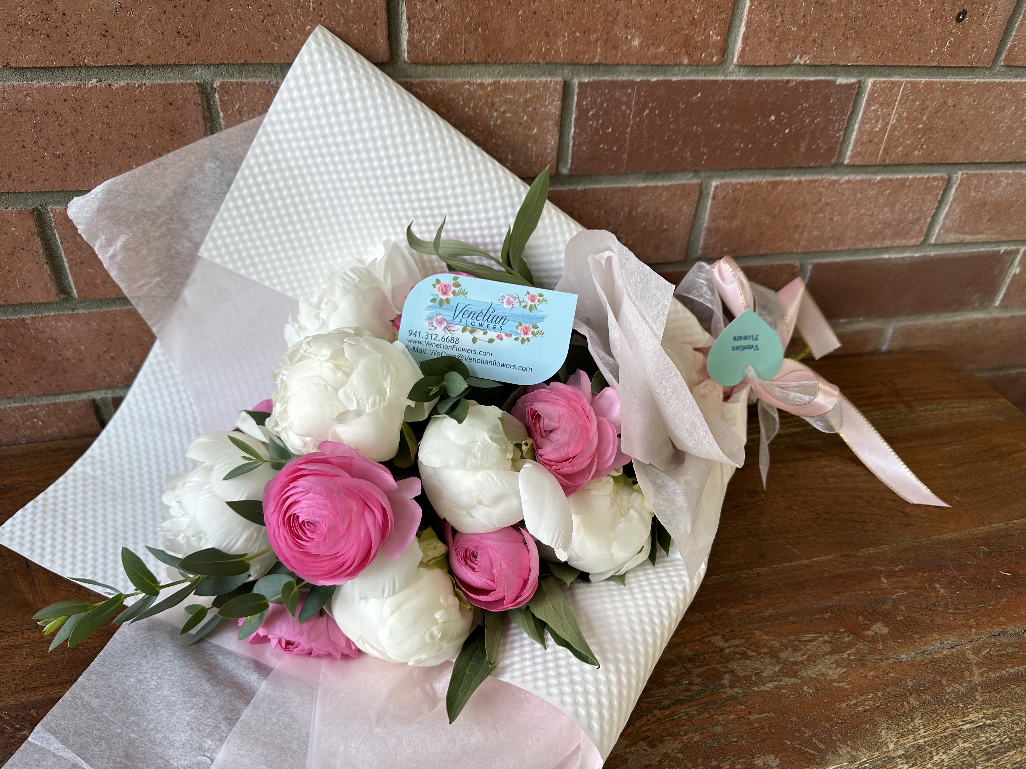 Lush Peonies &amp; Ranunculus Wrapped Bouquet  - Lovely fresh cut white peonies and pink ranunculus accented with wispy eucalyptus wrapped with high end tissues and elegant paper accented with pink and white ribbons.  