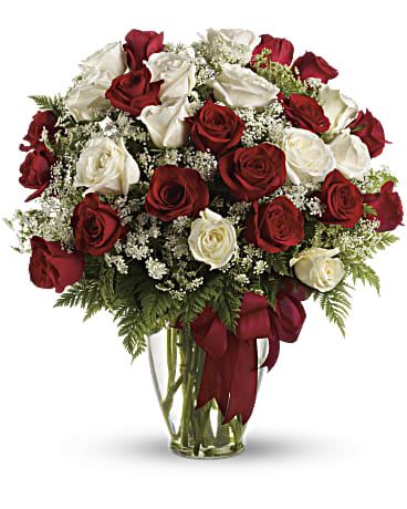 SEXY LOVE - It's like receiving an armful of love. This big, beautifully billowing bouquet of lush red and white roses in a sparkling Ming vase is guaranteed to take her breath away. She'll be dazzled, touched - and so glad that you're her guy. Red and white roses - accented with Queen Anne's lace and more - are delivered in a glass vase accented with a red satin ribbon. Orientation: All-Around 