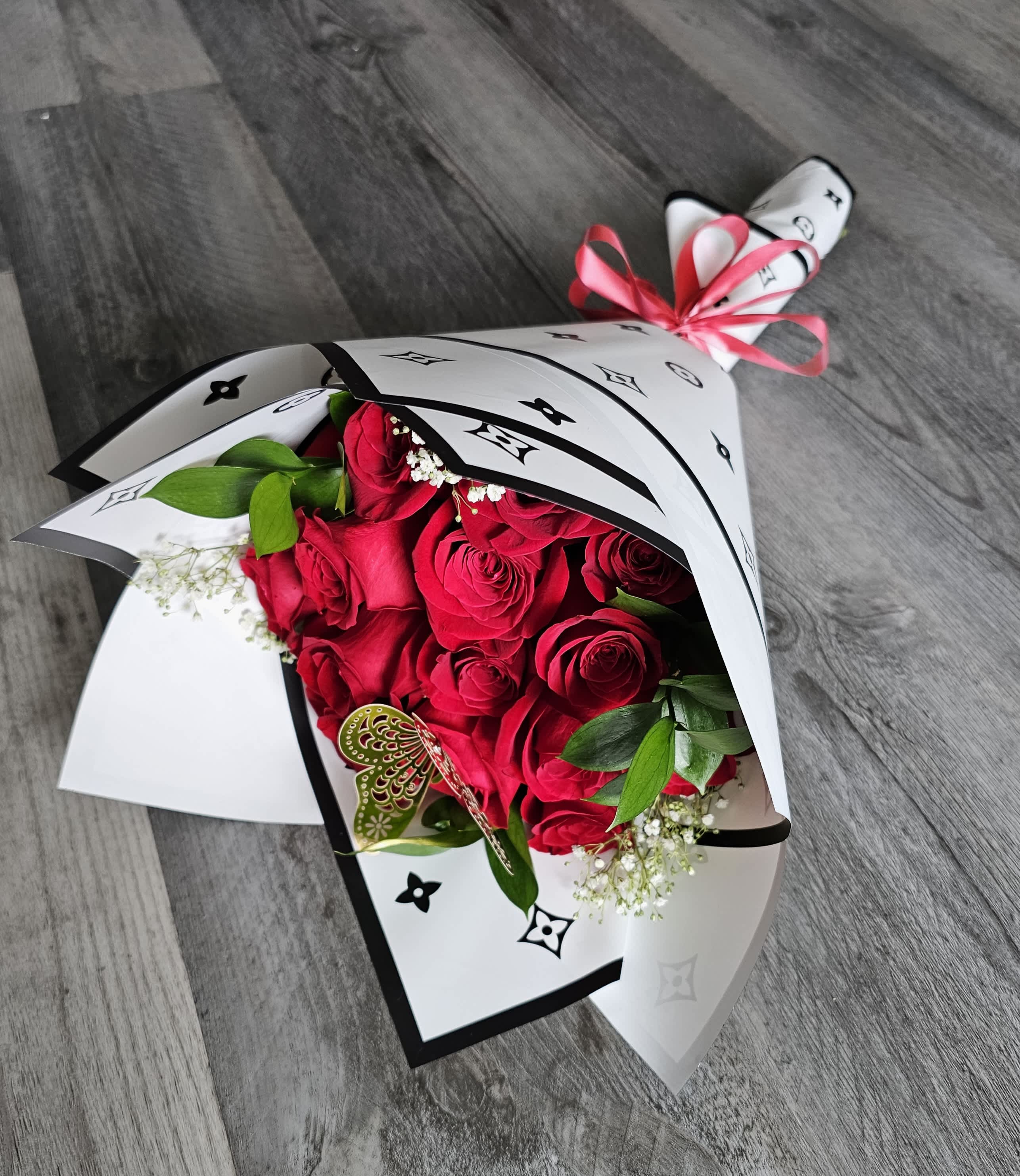 Dozen Luxury Rose Bouquet - Dozen Luxury Fresh Rose Bouquet, wrapped in a luxury wrap. (Chanel, Gucci, or Louis Vuitton) Accented with a gold butterfly. Deluxe has 25 stems and the premium has 50 stems. Please specify which brand wrap you prefer.
