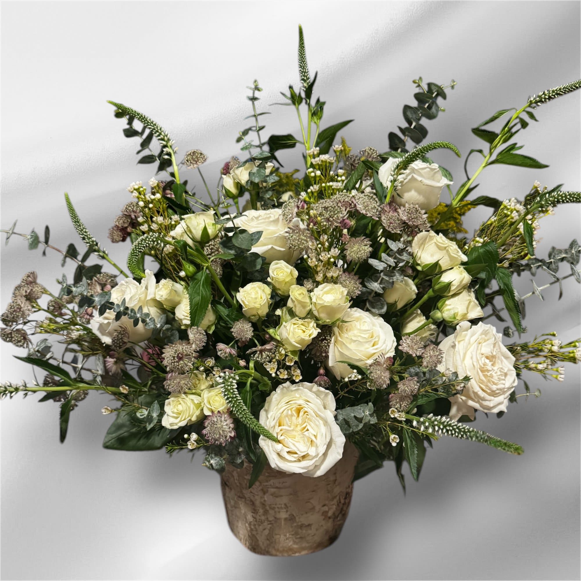 Blooming Wild  - White and green flowers arranged in a wooden flower box. 