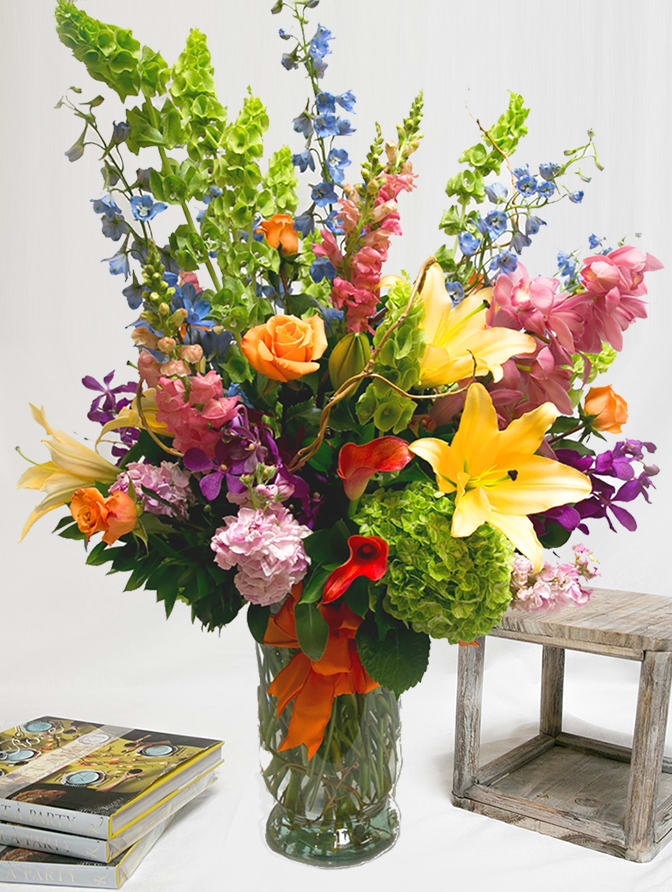Over The Top AD11 - Is there someone in your life that deserves an arrangement that is &quot;over the top?&quot; This incredible display of premium and seasonal flowers are artfully arranged in a large premium vase and accented with a french ribbon wired bow. Approximately 40&quot; tall x 20&quot; Wide