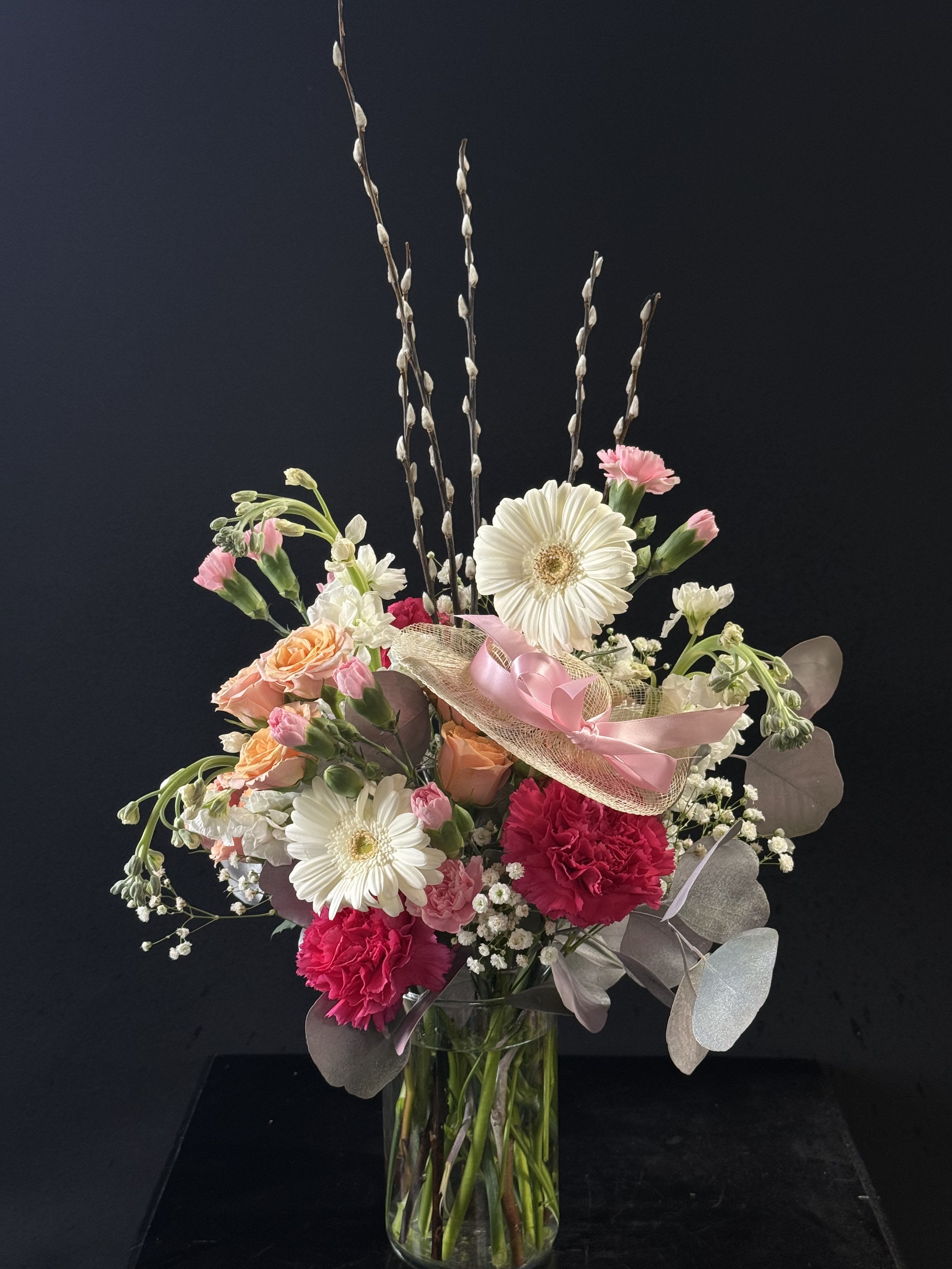 Hats Off To Mom - A unique and fun arrangement with gerberas, carnations, stock, mini carnations, spray roses, baby's breath, and eucalyptus.