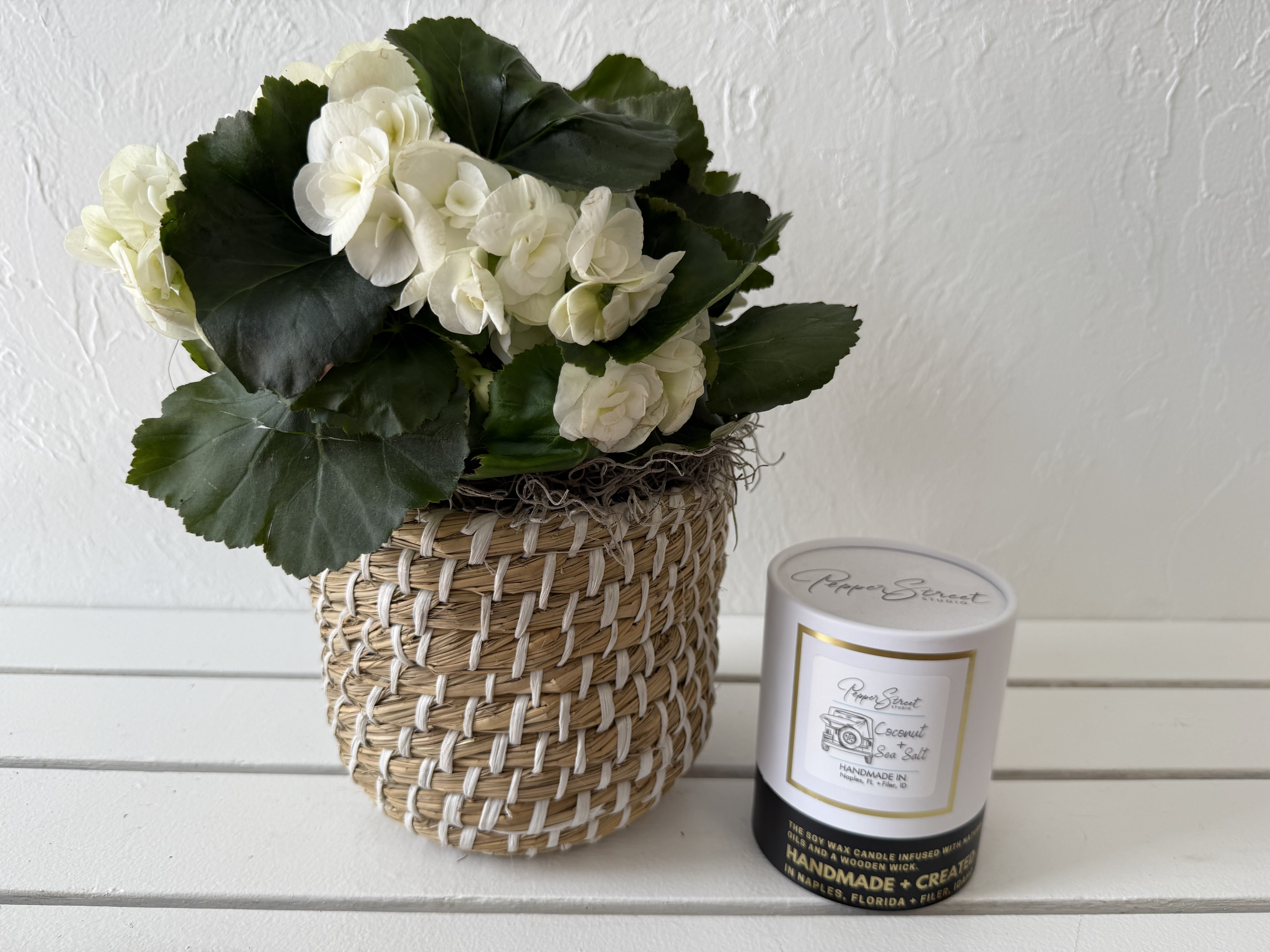 Naples Duo Naples Duo - Enjoy Naples vibes with a locally made, perfectly scented Sea Salt and Coconut candle. Paired with a white Begonia in 6" Sisal plastic lined basket.