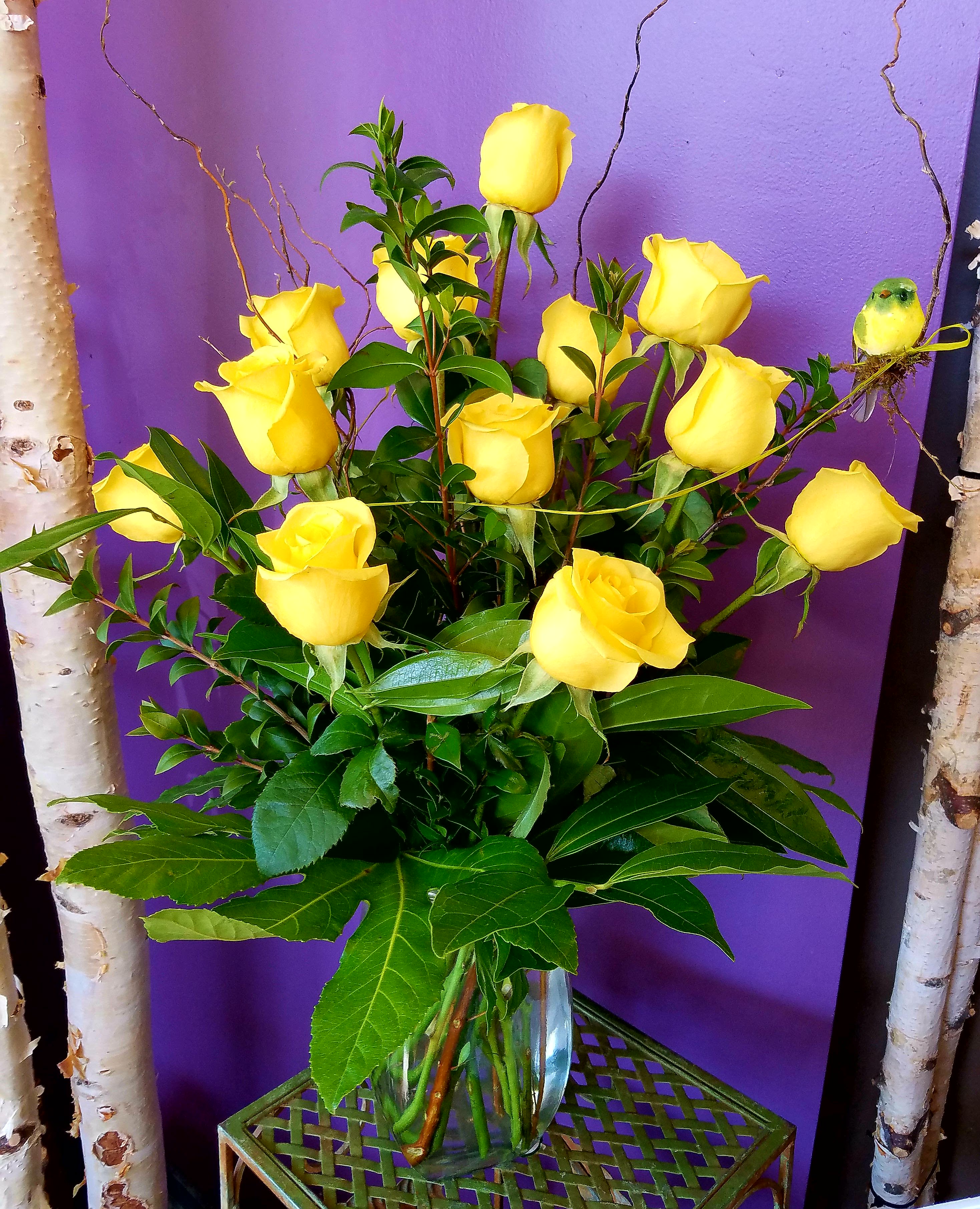 Eckert FLorist's Yellow Rose Bouquet Eckert FLorist's Yellow Rose Bouquet - This Yellow Rose Bouquet is a spectacular way to offer hope and warmth. Sunlit yellow roses are arranged with lush greens in a clear glass vase to create the perfect gift of caring and kindness.