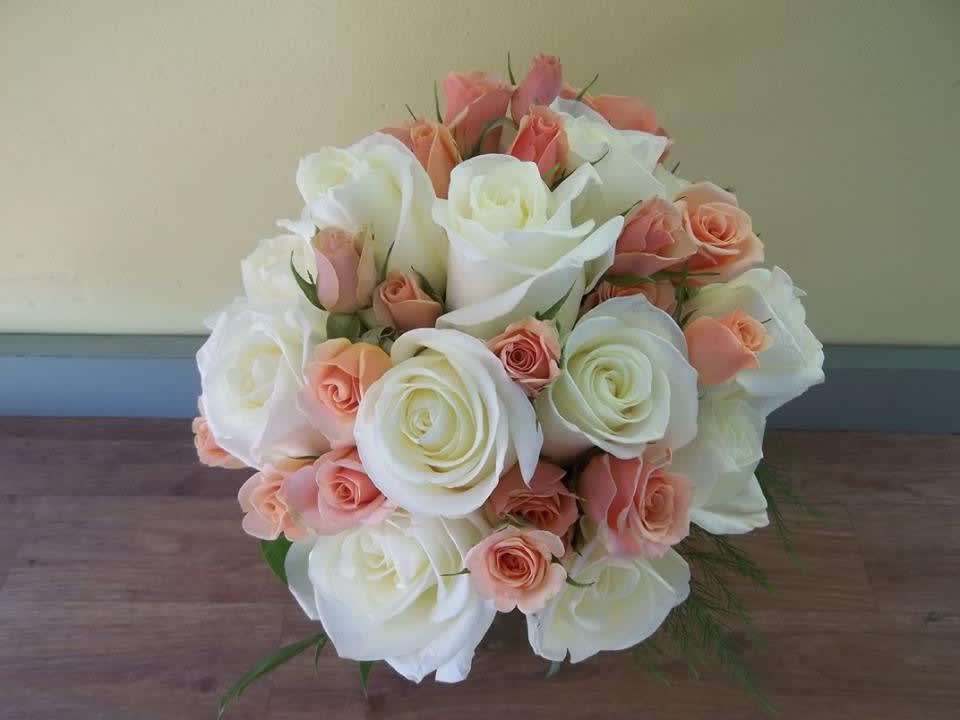 Hand tied Rose Bouquet. Hand tied Rose Bouquet. - A dozen white roses accented with soft pink spray roses and greenery. Hand tied with your choice of ribbon colors. For more pictures of our custom Bridal Bouquets.....visit our gallery "Weddings".
