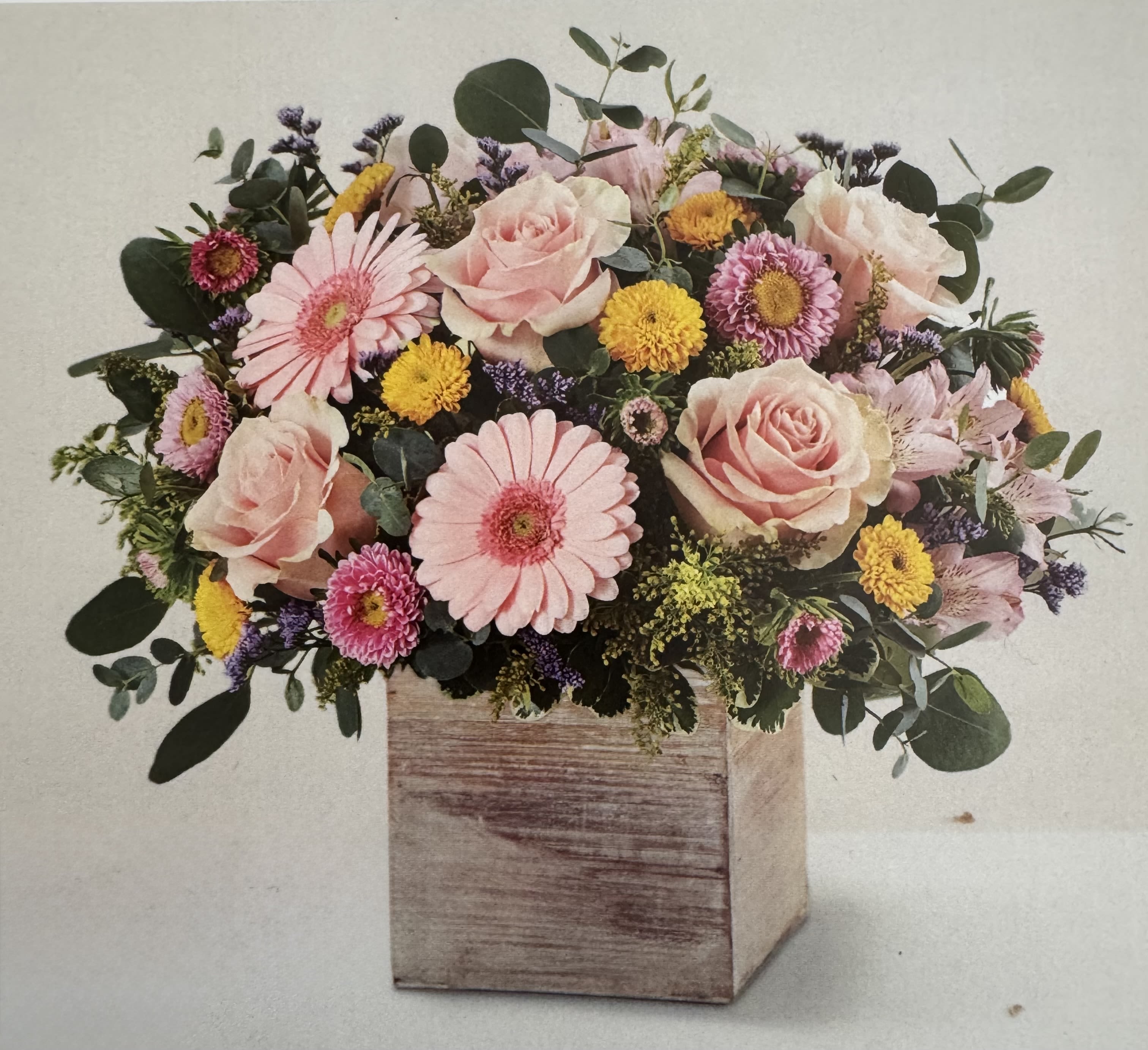 Blooming with Deliight Blooming with Deliight - A combination of blooms arranged in a wooden cube. Perfect for any occasion!