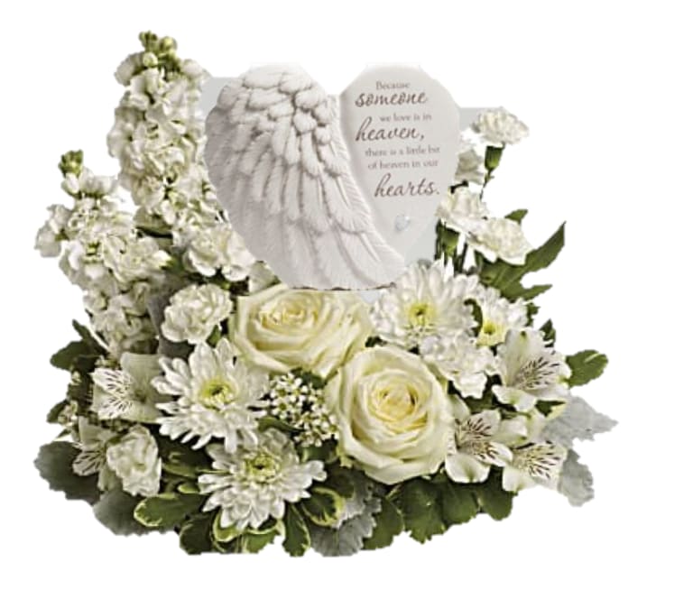 Hearts in Heaven Bouquet - Share your heart and show your love with this magnificent display of green and white blooms, gracefully surrounding an angel's wing keepsake with a loving message of sympathy. Message on sculpt reads: &quot;Because someone we love is in heaven, there is a little bit of heaven in our hearts.&quot;  *one-sided*