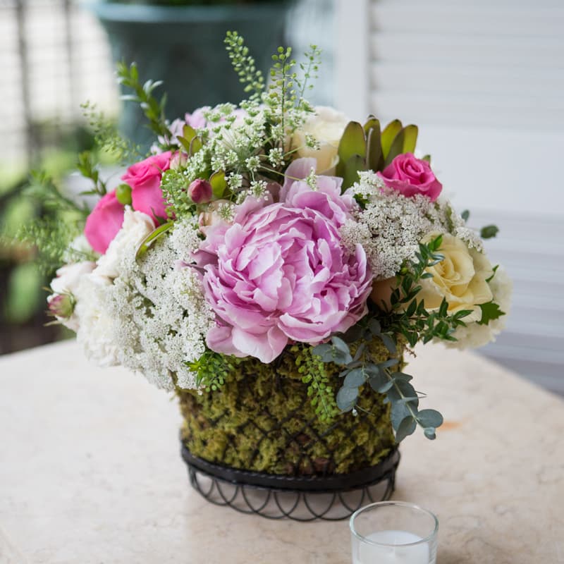 Southern Belle Southern Belle - Mix of pink, white, and yellow blooms. This French wire basket is currently on back order. we will substitute a French/Provence style clay pot. If peonies are not available, we will use lush garden roses.