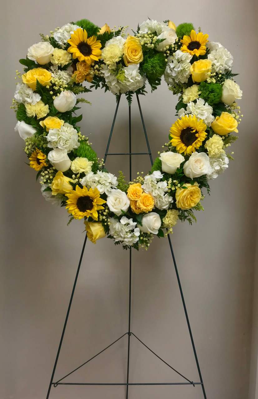 Golden Sunflower - This Golden Sunflower Easel Spray is the perfect sympathy tribute for a funeral or memorial service. Artfully arranged with sunflowers for a vibrant, sunny display, this spray also includes fresh roses, hydrangeas, and beautiful carnations. The assortment of warm yellow and white hues evoke peace, love, and fond memories of the departed, providing a fitting reminder of the beauty of life. 