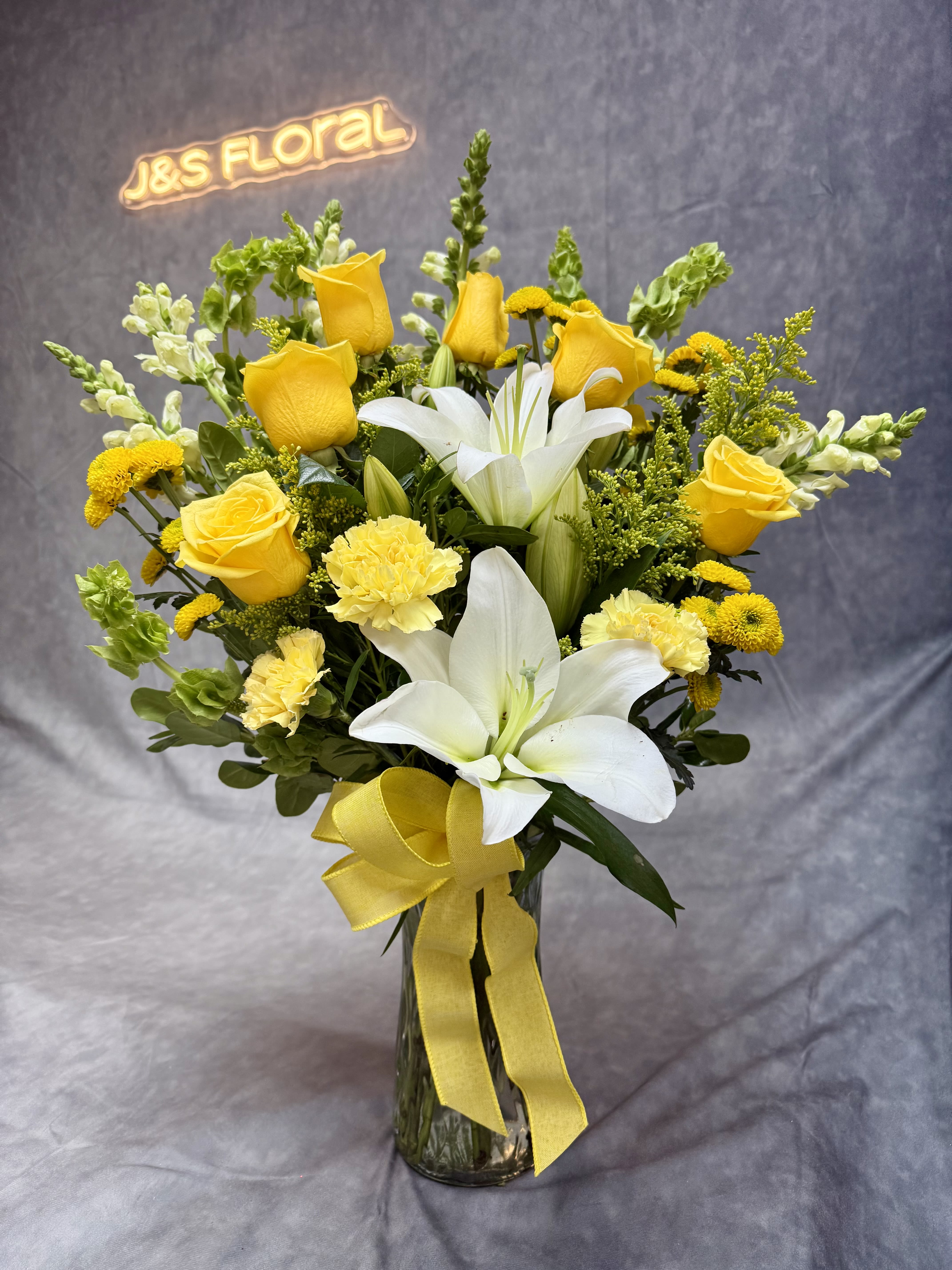 Yellow breeze - A refreshing blend of vibrant yellow roses and spray roses , yellow alstroemeria and elegant white lilies , capturing the essence of gentle breeze . Perfect for spreading warmth , joy and positivity in any space.