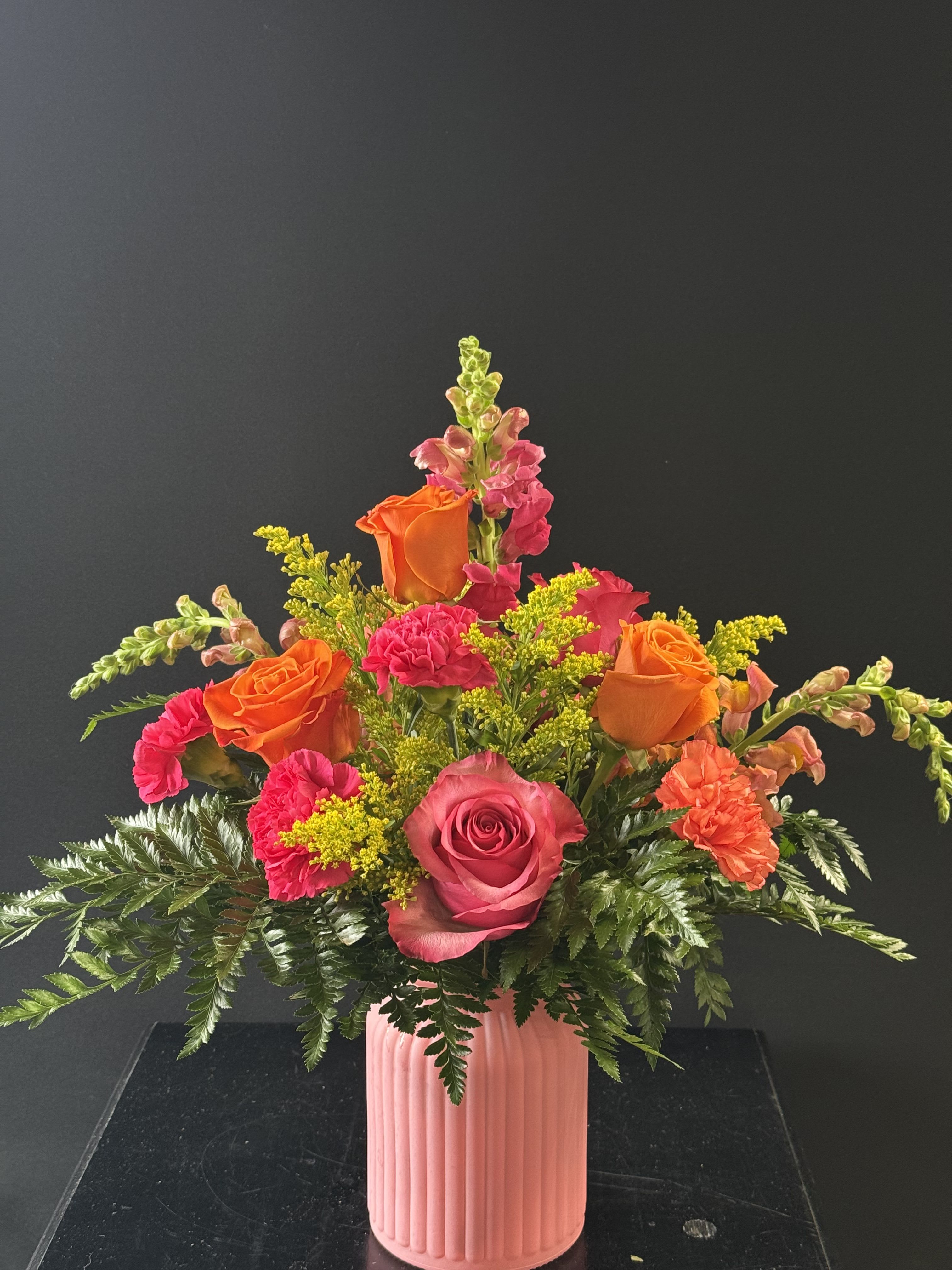 Starburst - A very bold and bright arrangement with orange, yellow, and pink flowers. A great way to brighten someone's day!