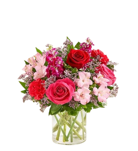 Romantic Reverie - Dreamy and elegant bouquet that captures the essence of love. Features roses, carnations, stock/snapdragon, limoniums, greenery and vase.  