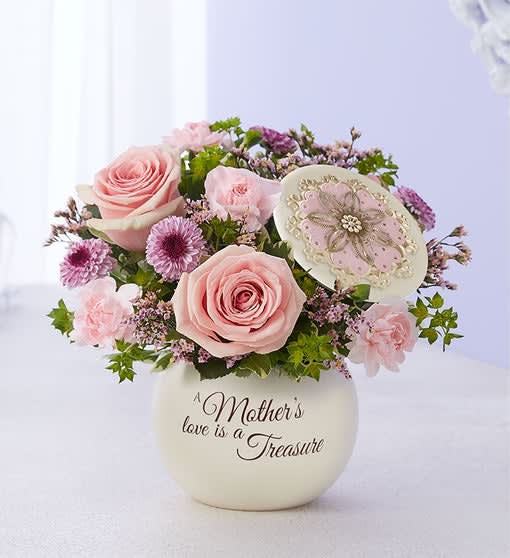 1-800 A Mother's Love™ 1-800 A Mother's Love™ - A mother’s love is something to treasure. This sentiment is so beautifully captured in our garden-inspired bouquet, featuring a mix of pastel blooms in our vintage-inspired canister. With an elegant, floral-embellished lid and heartfelt message, this timeless keepsake can later be used to hold jewelry or trinkets for a lasting reminder of the special bond you share.