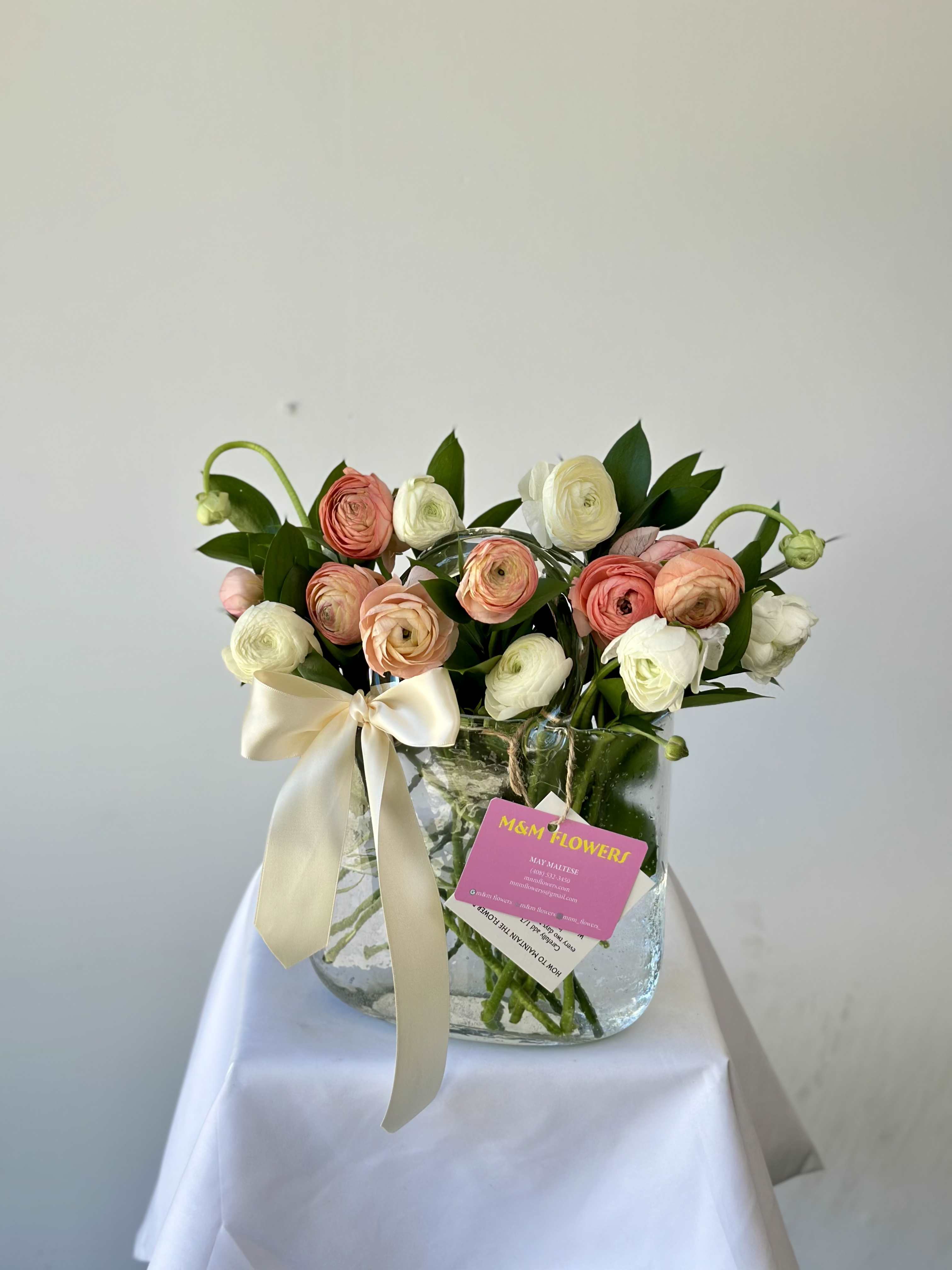 Hand Bag Vase Arrangement - Meet our stunning arrangement!   Deliver happiness with this magnificent floral design that features a modern hand bag vase with 20 stems of gorgeous Tulips.   Unique and breathtakingly beautiful!  We kindly ask to add to the order notes your color preference for the arrangement.  Arrangement includes:  - Glass vase - Fresh flowers - Flower care instructions card - Custom greeting message card