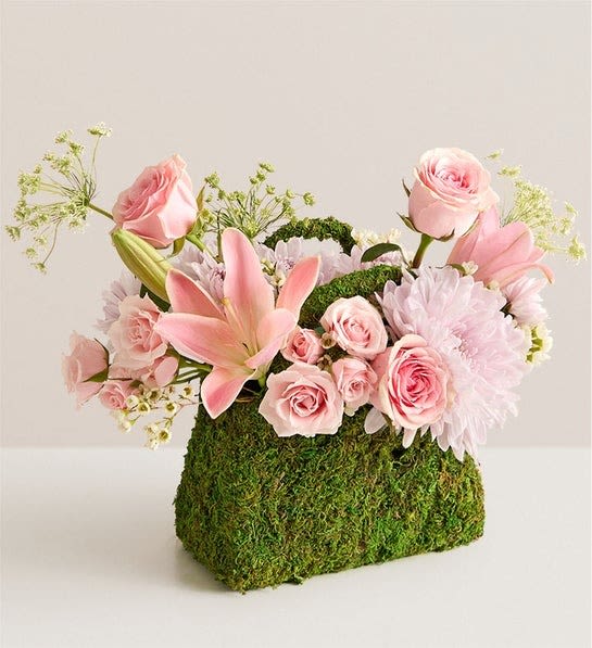 Palermo Blush Palermo Blush - NEW This just might be the most fashionable, and Insta-worthy, bouquet ever. An eye-catching array of pink roses and other blooms burst forth beautifully from a planter shaped like a handbag and clad in preserved moss. After the blooms are gone, the planter will retain its elegance, making this a truly timeless gift.