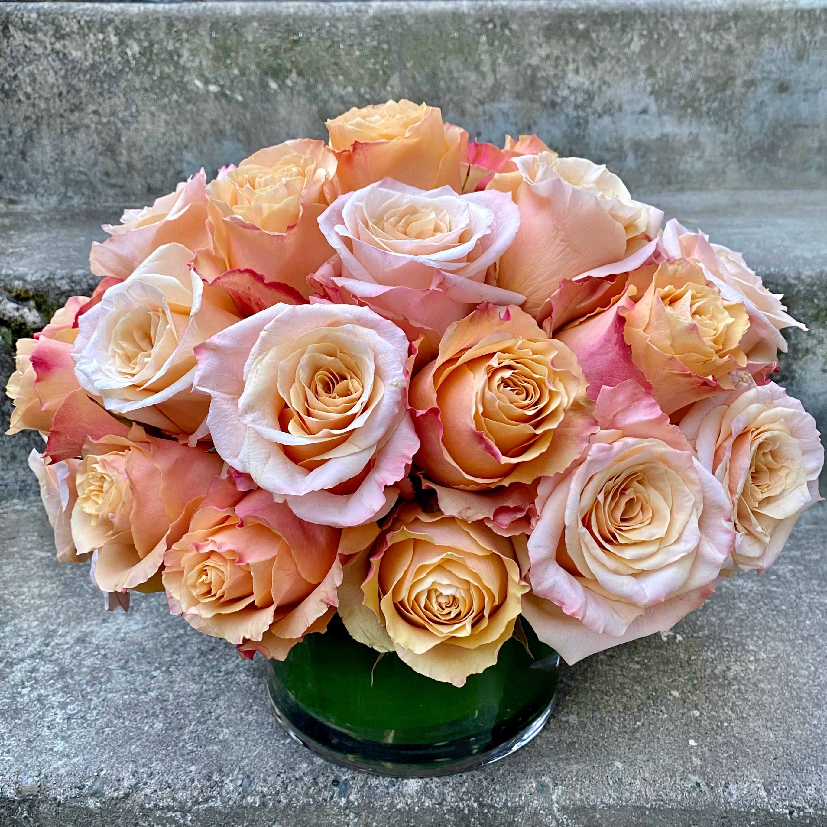 Three Dozen Classic Roses - Designer's Choice Color - Classic, simple, perfect. Three dozen premium roses arranged without filler or fuss in a clear glass vase with a leaf-wrapped interior.  If you have color preferences, please specify your first and second choices in the &quot;Florist Instructions&quot; section upon checkout. Please allow two business days for some special requests to be delivered or call us to see what colors of roses we currently have in stock. Or you can choose not to specify and leave it to us! We will create an arrangement using the best roses that we have available on the day of delivery. For red roses, please order 'Classic Red Roses.  Approximately 10 inches high by 11 inches wide