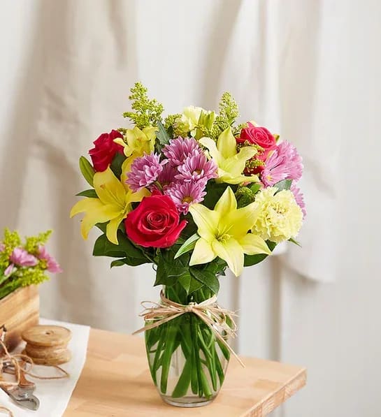 Fields of Europe® for Mom Fields of Europe® for Mom - Mom is in for a beautiful surprise! Our best-selling Mother’s Day arrangement is designed in the same tradition as the hand-tied bouquets found in European flower markets. A vibrant mix of blooms inside a glass vase tied with raffia, it’s a gift that delights with old-world charm and style. All-around arrangement with hot pink roses; yellow Asiatic lilies and carnations; lavender daisy poms; solidago; accented with assorted greenery Artistically designed in clear glass vase tied with raffia; measures 8"H Extra large arrangement measures approximately 18"H x 14"W Large arrangement measures approximately 17"H x 13"W Medium arrangement measures approximately 16"H x 12"W Small arrangement measures approximately 15"H x 11"W Our florists hand-design each arrangement, so colors, varieties and container may vary due to local availability To ensure lasting beauty, Asiatic lilies may arrive in bud form and will fully bloom over the next few days