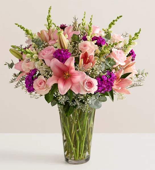 Marvelous Mom™ Marvelous Mom™ - NEW A dazzling gathering of pink and purple, this bouquet will delight all the marvelous moms in your life. Our florists artistically arrange farm-fresh roses, Asiatic lilies, and other blooms to create a gift that expresses your love and appreciation in a way words never could. All-around arrangement of pink roses and Asiatic lilies, purple dianthuses and limoniums, white snapdragons, baby’s-breath (gypsophila), and greenery Artistically designed in a clear glass vase; measures 12”H Large arrangement measures approximately 23”H x 18”W Medium arrangement measures approximately 22”H x 14”W Small arrangement measures approximately 21”H x 13”W Our florists hand-design each arrangement, so colors and varieties may vary due to local availability To ensure lasting beauty, Asiatic lilies may arrive in bud form and will fully bloom over the next few days