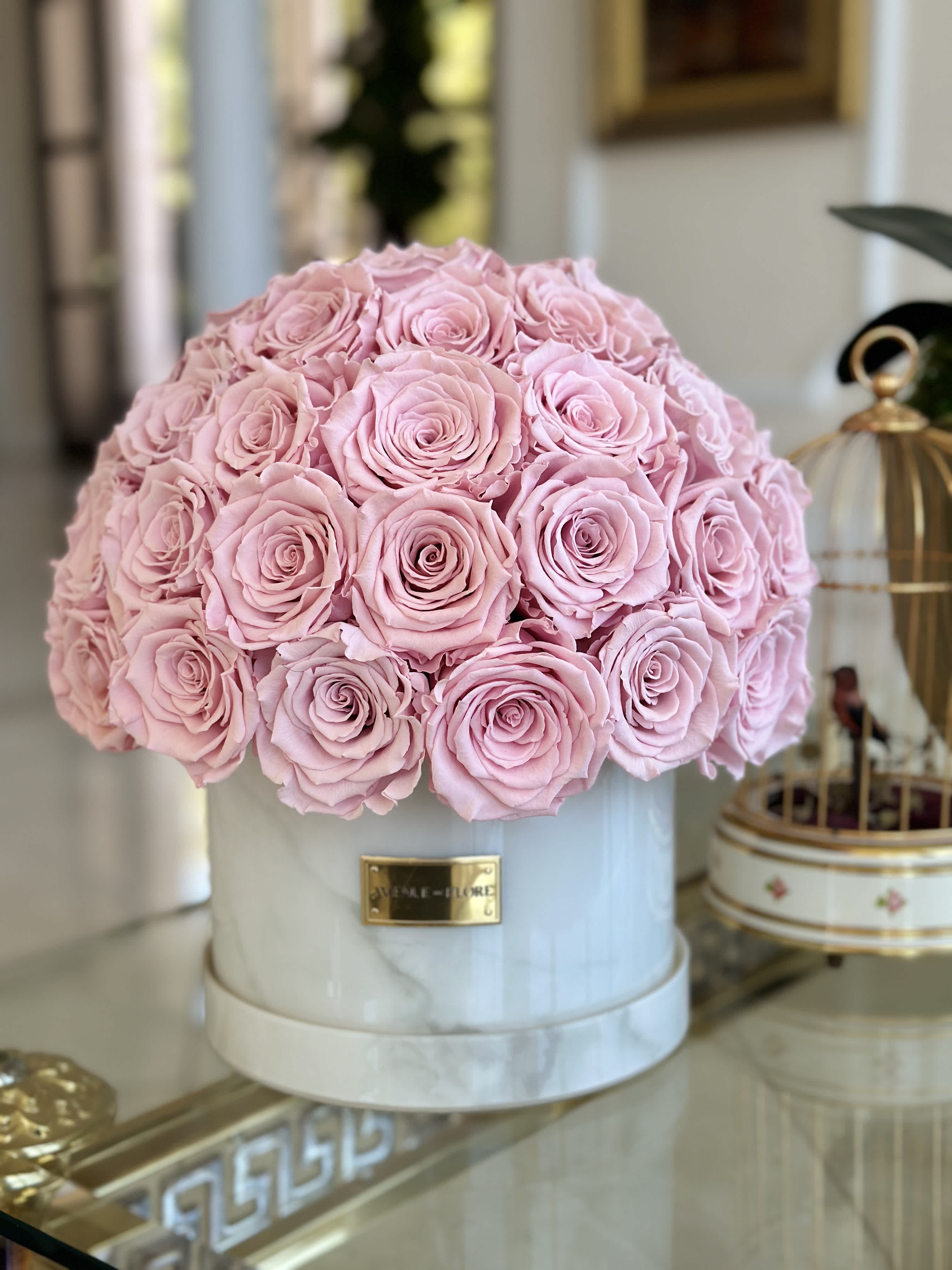 White Marble Dome - Pink Preserved Roses - Introducing our luxurious Marble Acrylic Box - a stunning choice for displaying your roses that will last a year. This exquisite home decor piece is available in elegant White Marble and holds over 50+ premium pink roses. PRESERVED ROSES. Photo features deluxe.  