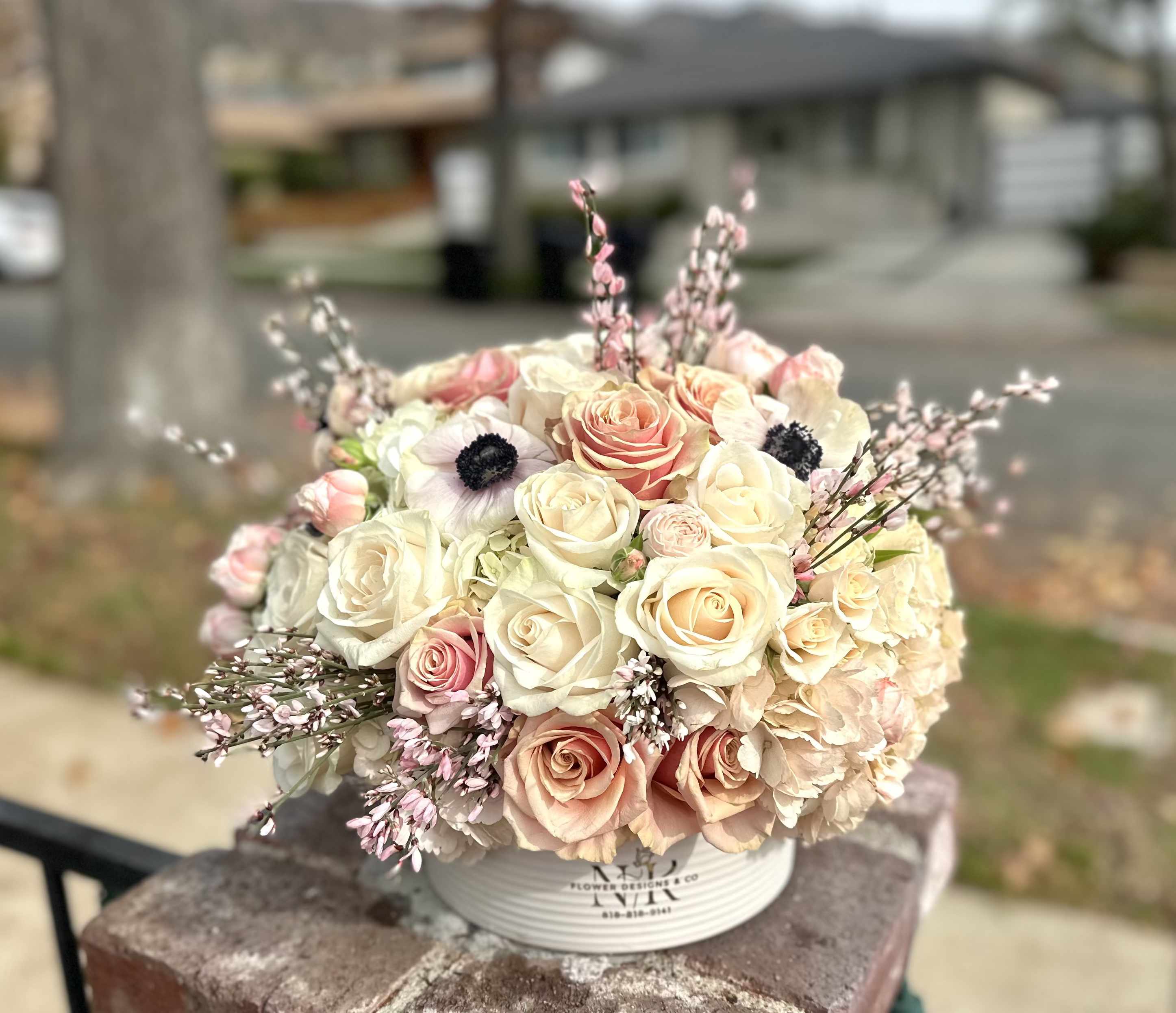 Unique Elegance - Delicate color combination of freshest flowers in a white ceramic container - excellent choice for any occasion!