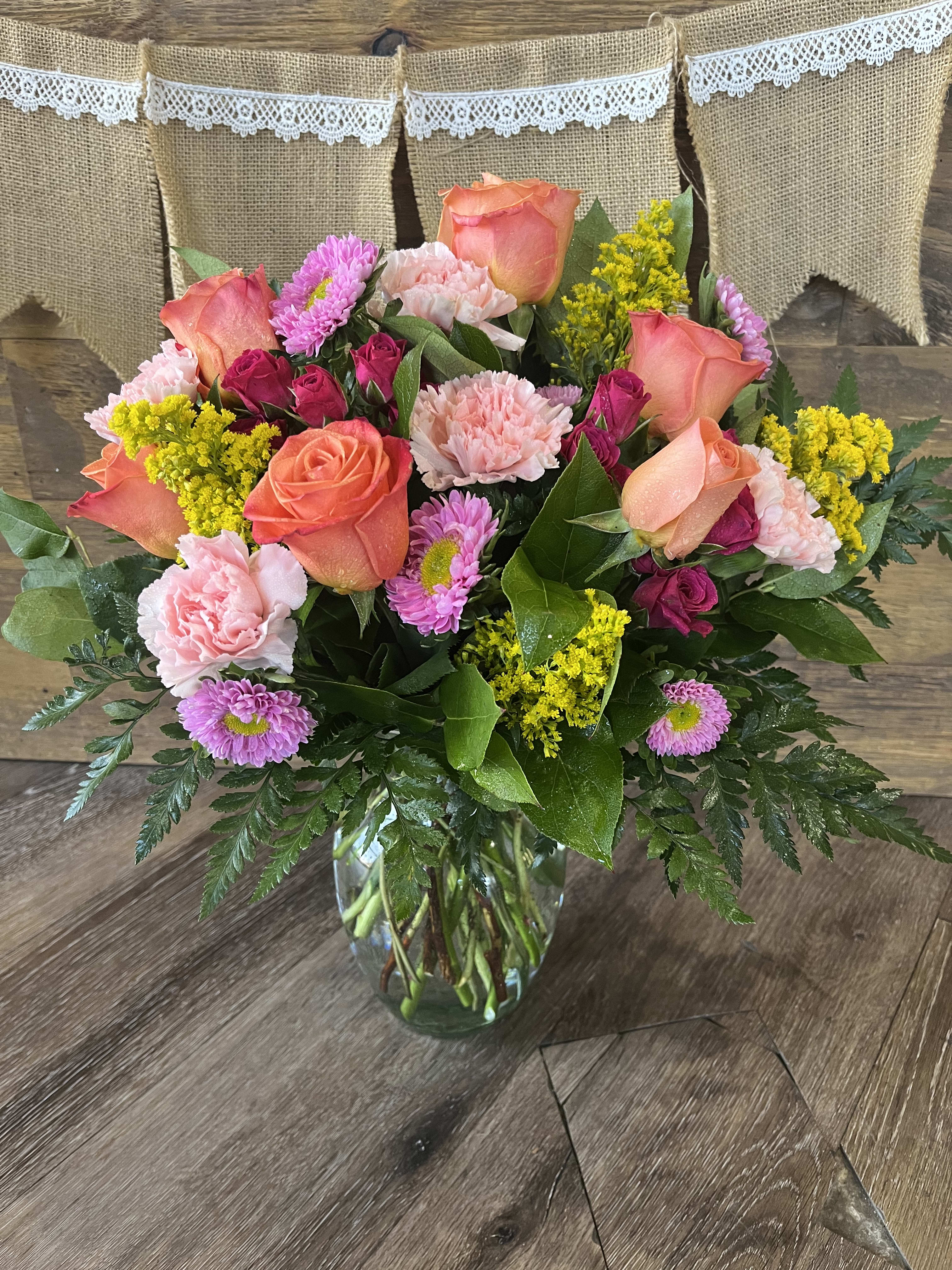 How Sweet It Is - A bright and sweet arrangement of orange roses, carnations, spray roses and more! 