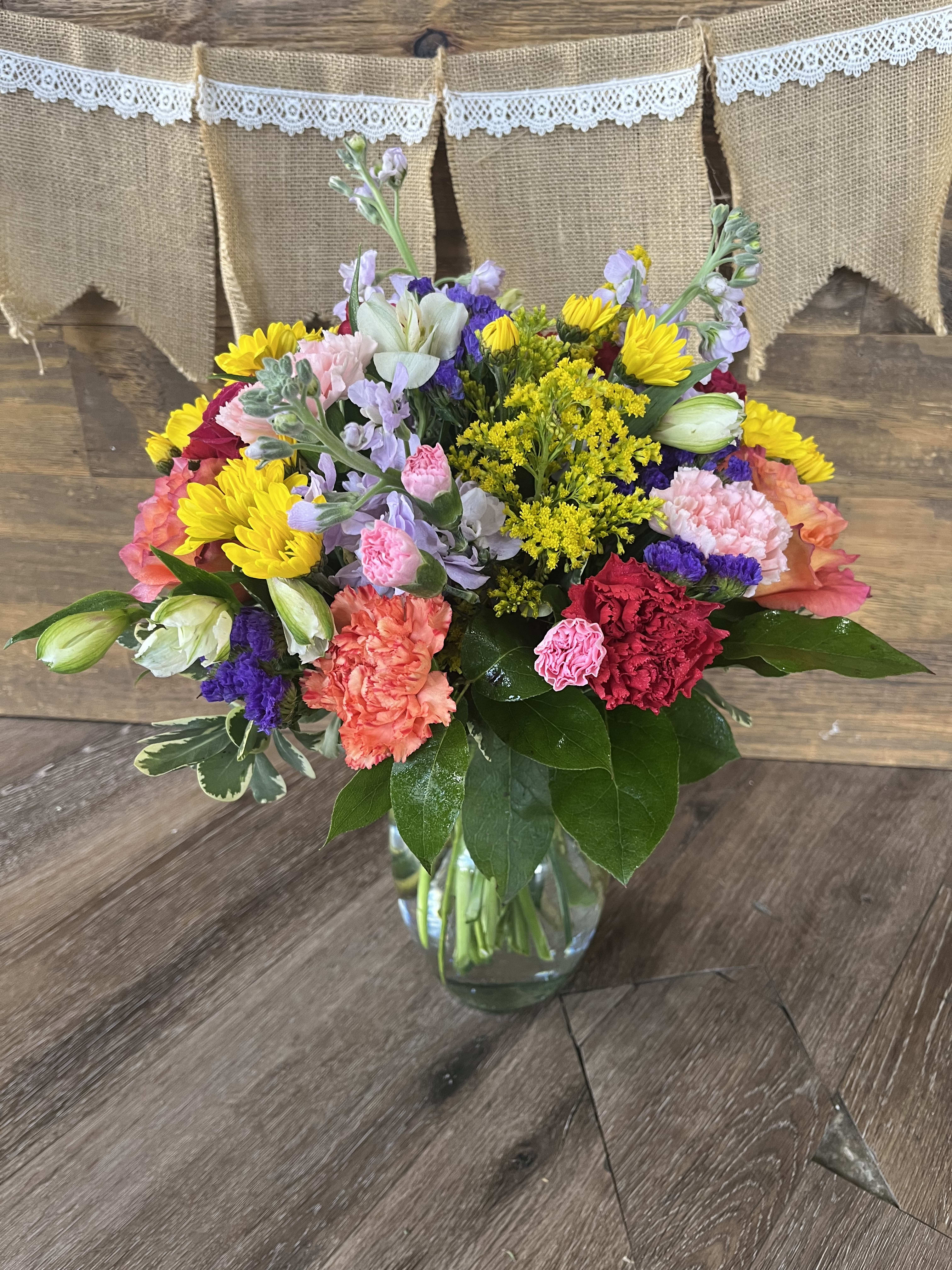 Life of the Party Life of the Party - Celebrate good times with this lively bouquet. The arrangement includes roses, carnations, alstroemeria, stock, aster, and other seasonal blooms. This is the perfect gift for Mother's Day, Birthday, or Just Because. APPROXIMATE DIMENSIONS: 12" D x 15"H
